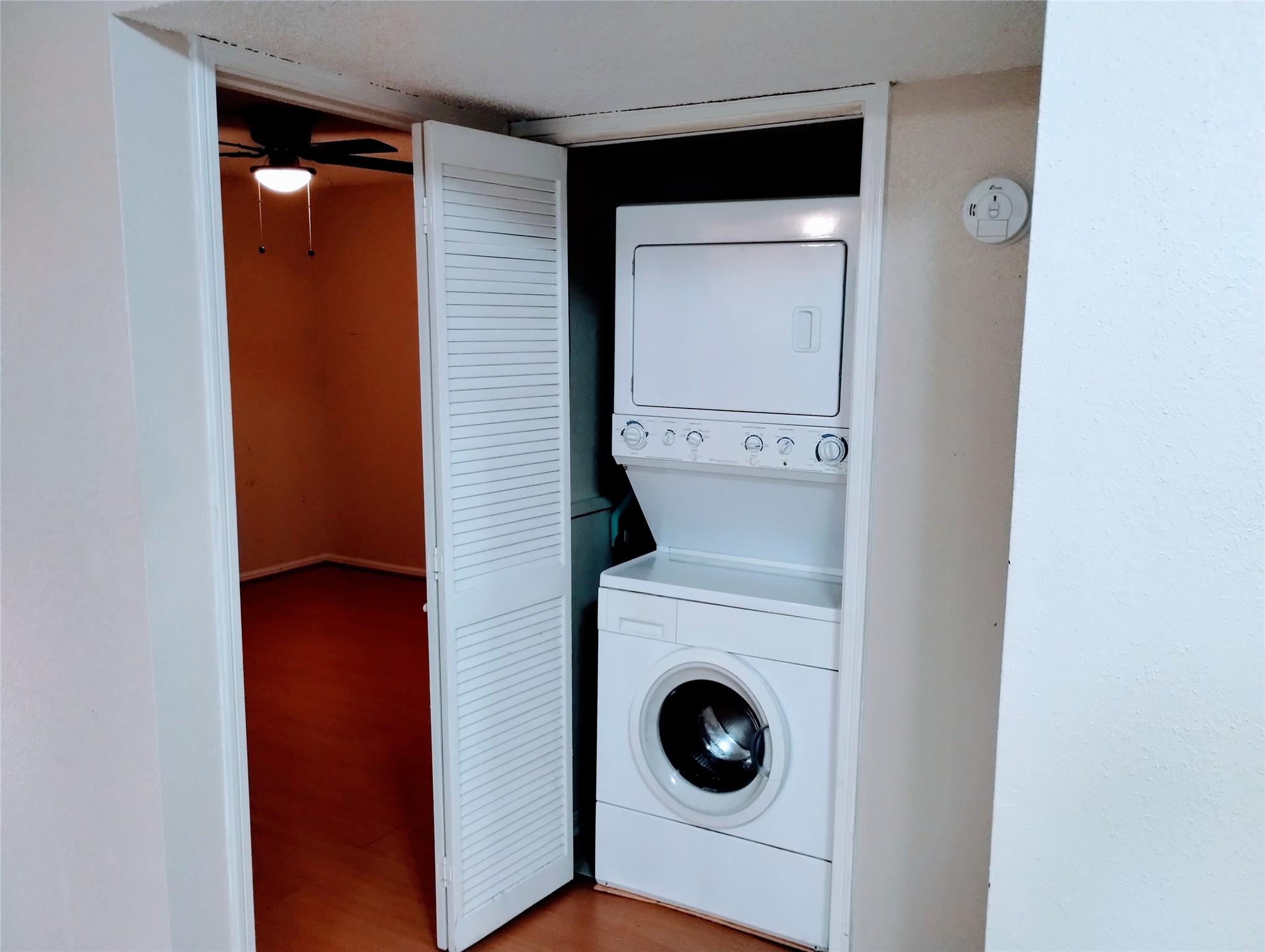 Between the Primary Bedroom and Full Bath is the LAUNDRY space with a stackable washer & dryer covered by louvered, bi-fold doors.