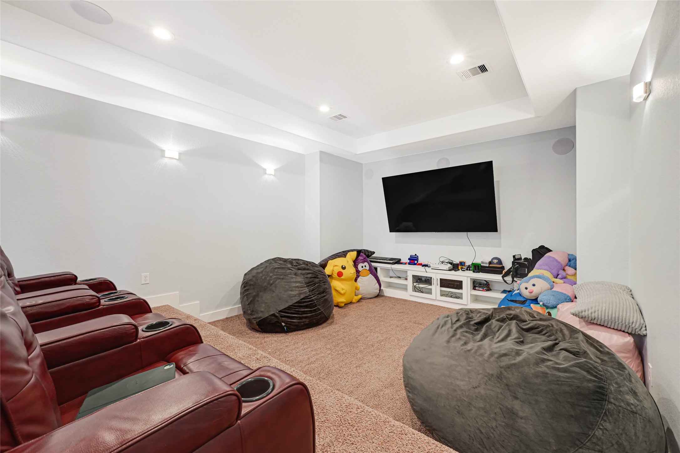 Spacious media room provides a comfortable setting for movie nights and entertainment.