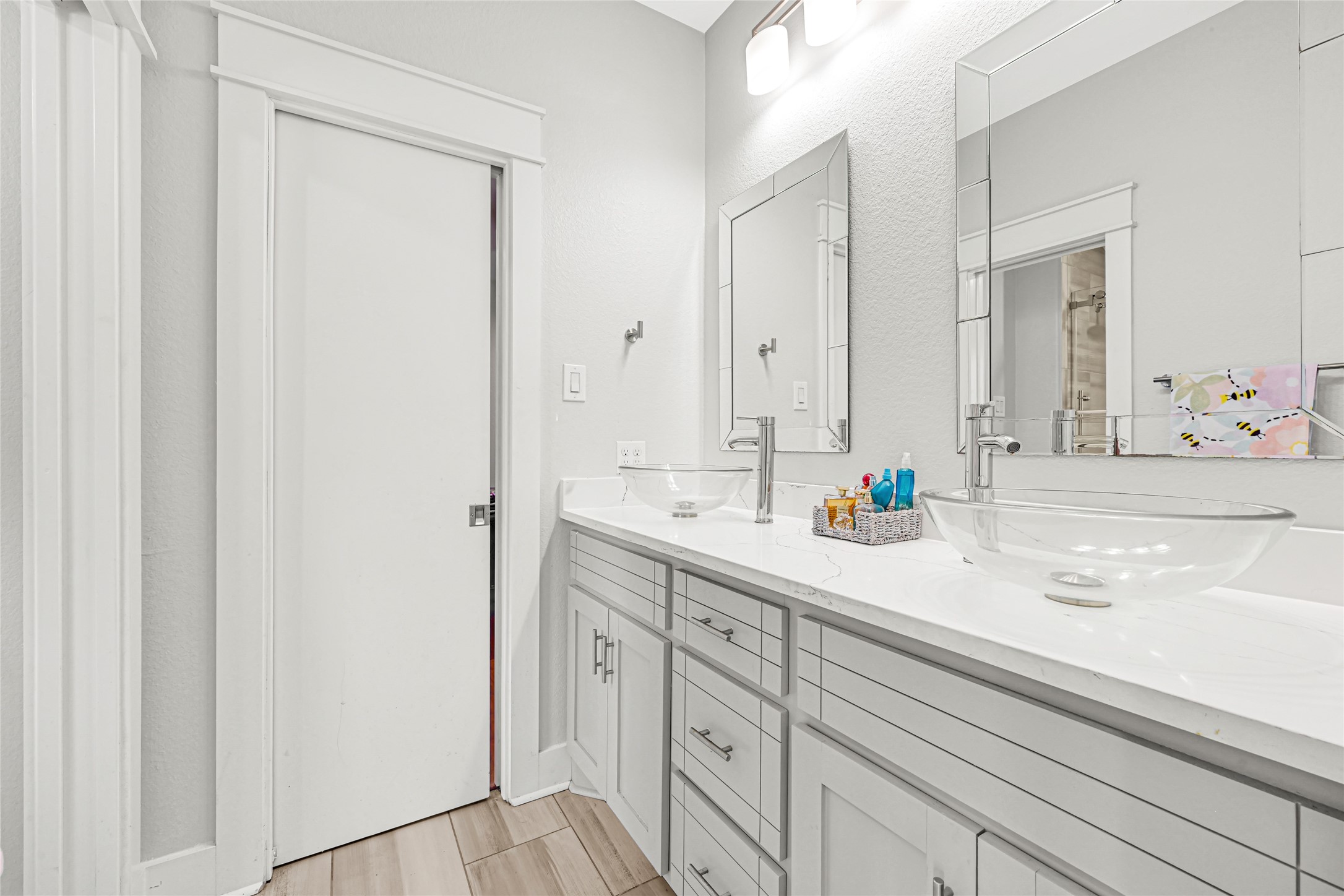 Spacious bathroom vanity with generous counter space, cabinet storage, and a large mirror.