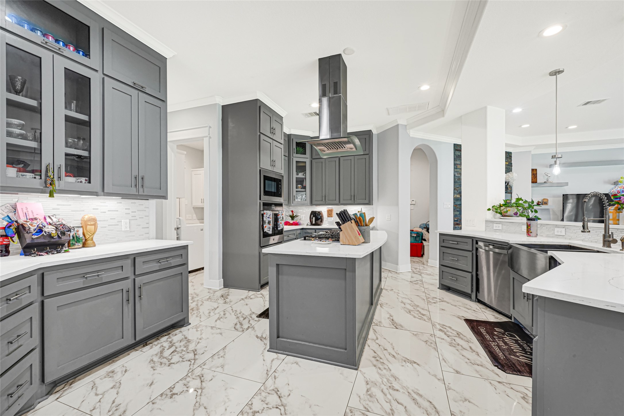 Spacious kitchen features abundant cabinetry, generous counter space, and a central cooking island.