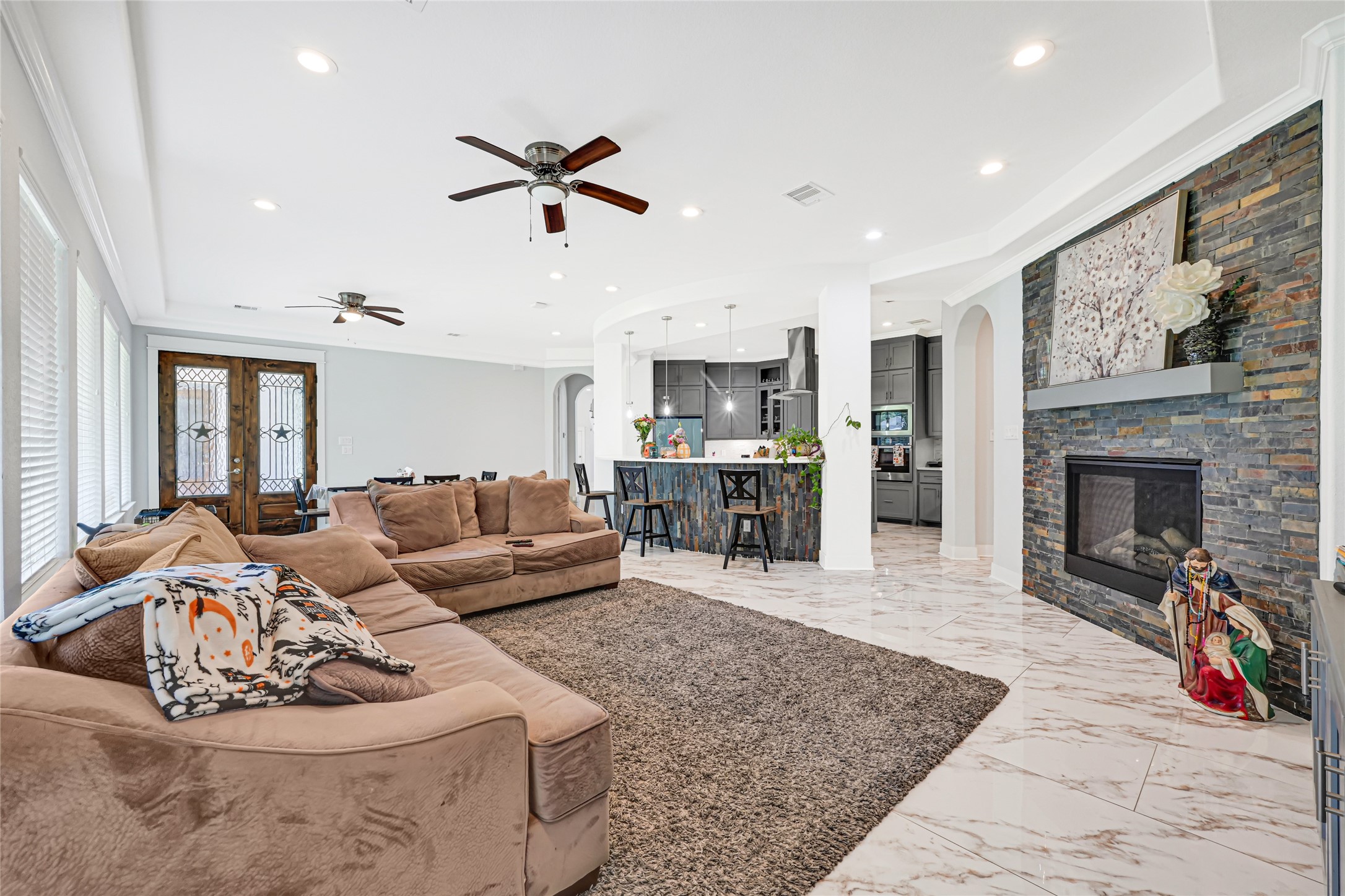 An alternate view highlights the family rooms generous seating area and connection to the kitchen.