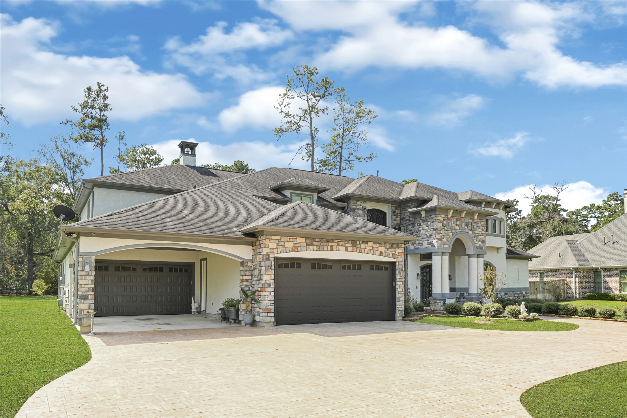 Four-car garage and expansive driveway provide ample parking.