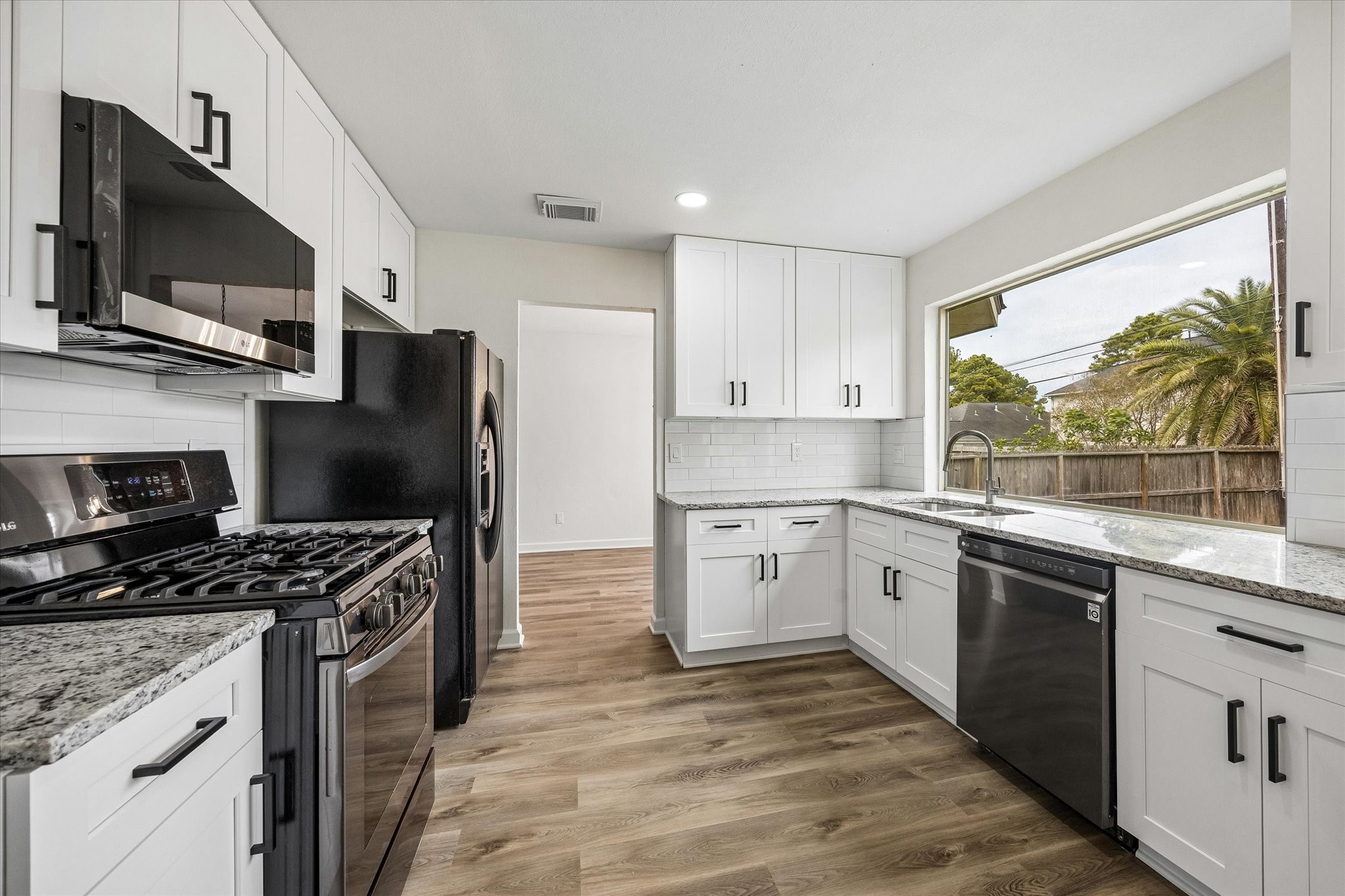 Beautiful, oversized windows offer peaceful views of your backyard while you cook, bringing natural light and a touch of the outdoors into your kitchen.