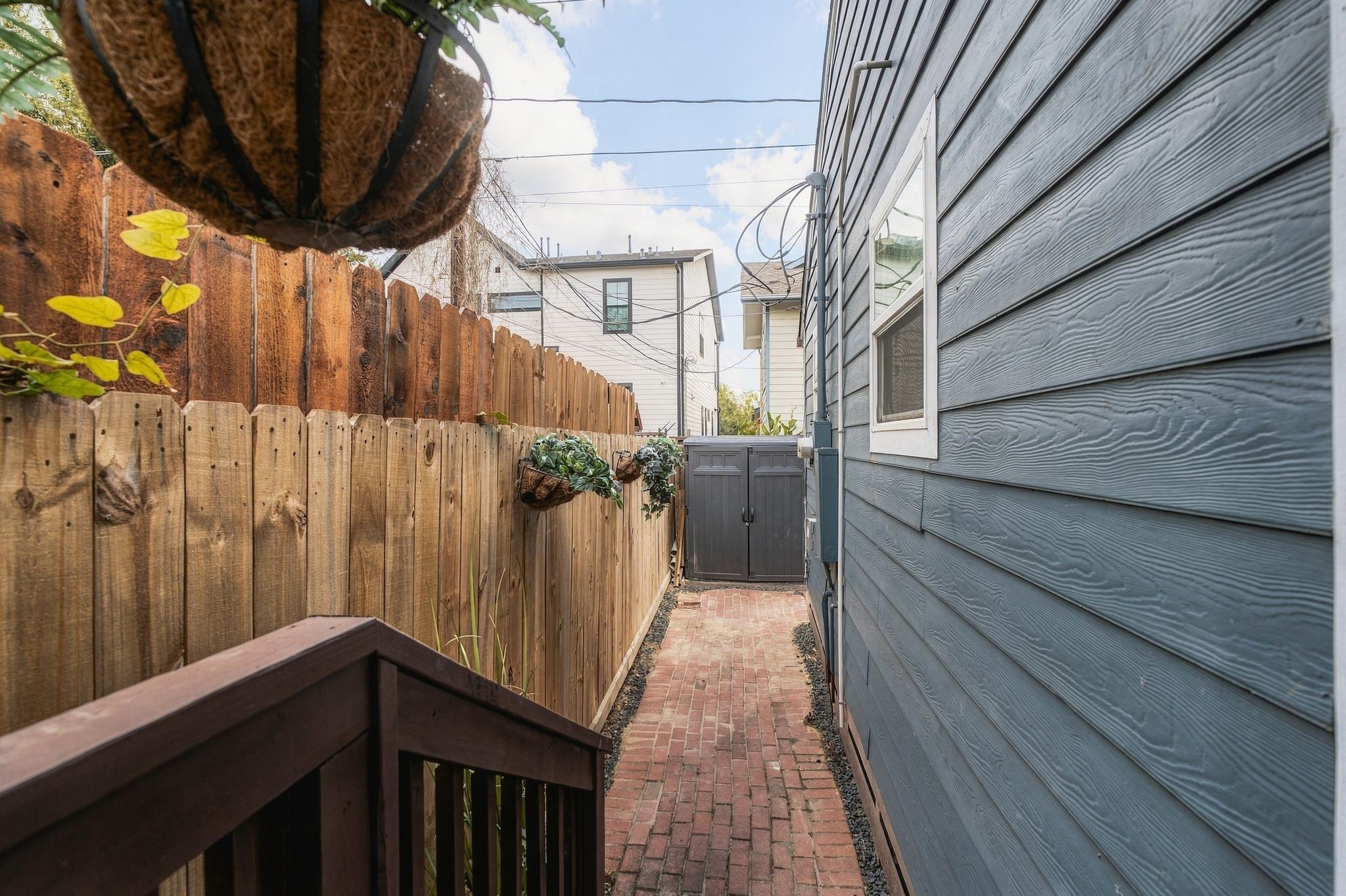 Fenced rear exterior with additional paved outdoor space, offering opportunities for entertaining, container gardening, or creating a personalized patio retreat in the heart of Brooke Smith.
