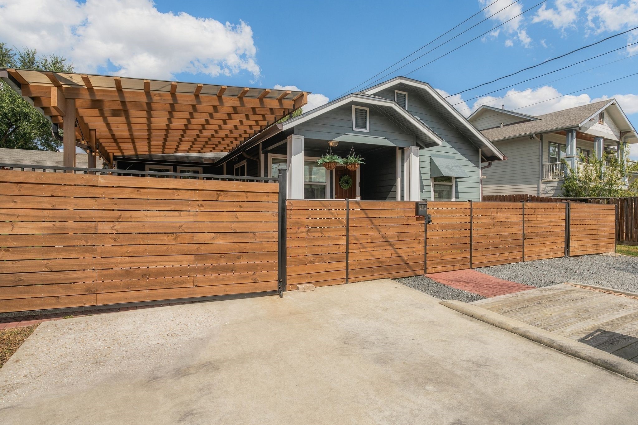 Rare double-wide driveway with gated access to a covered carport that can also serve as a flexible outdoor entertaining space. Exceptional off-street parking for this established Inner Loop neighborhood.