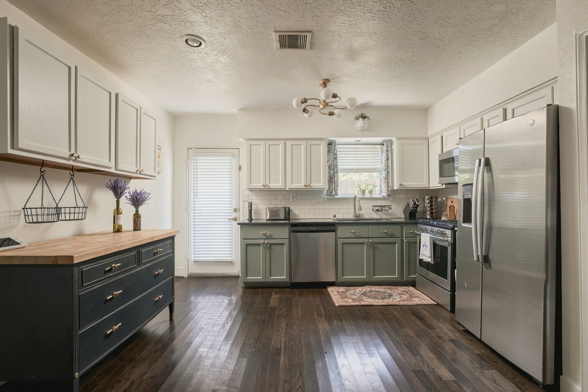 Open kitchen with convenient access to the rear exterior, connecting indoor living with the home's private outdoor spaces. An efficient layout designed for comfortable everyday living.