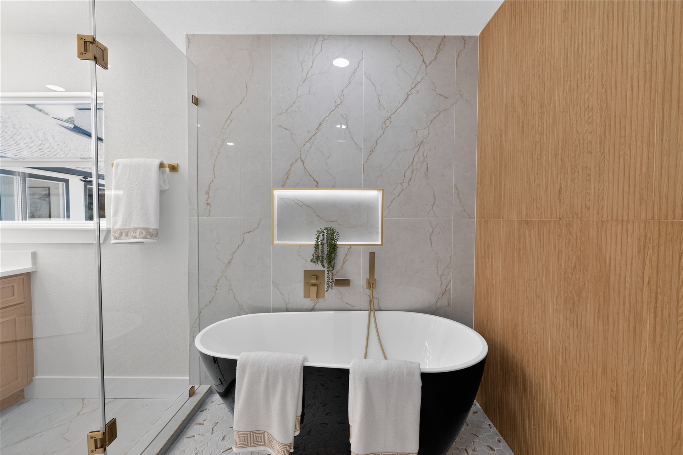 Beautiful soaking tub inside large shower.
