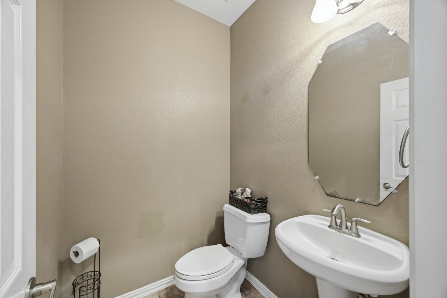 Conveniently located off the main living areas, this charming powder room offers a welcoming half-bath for guests.