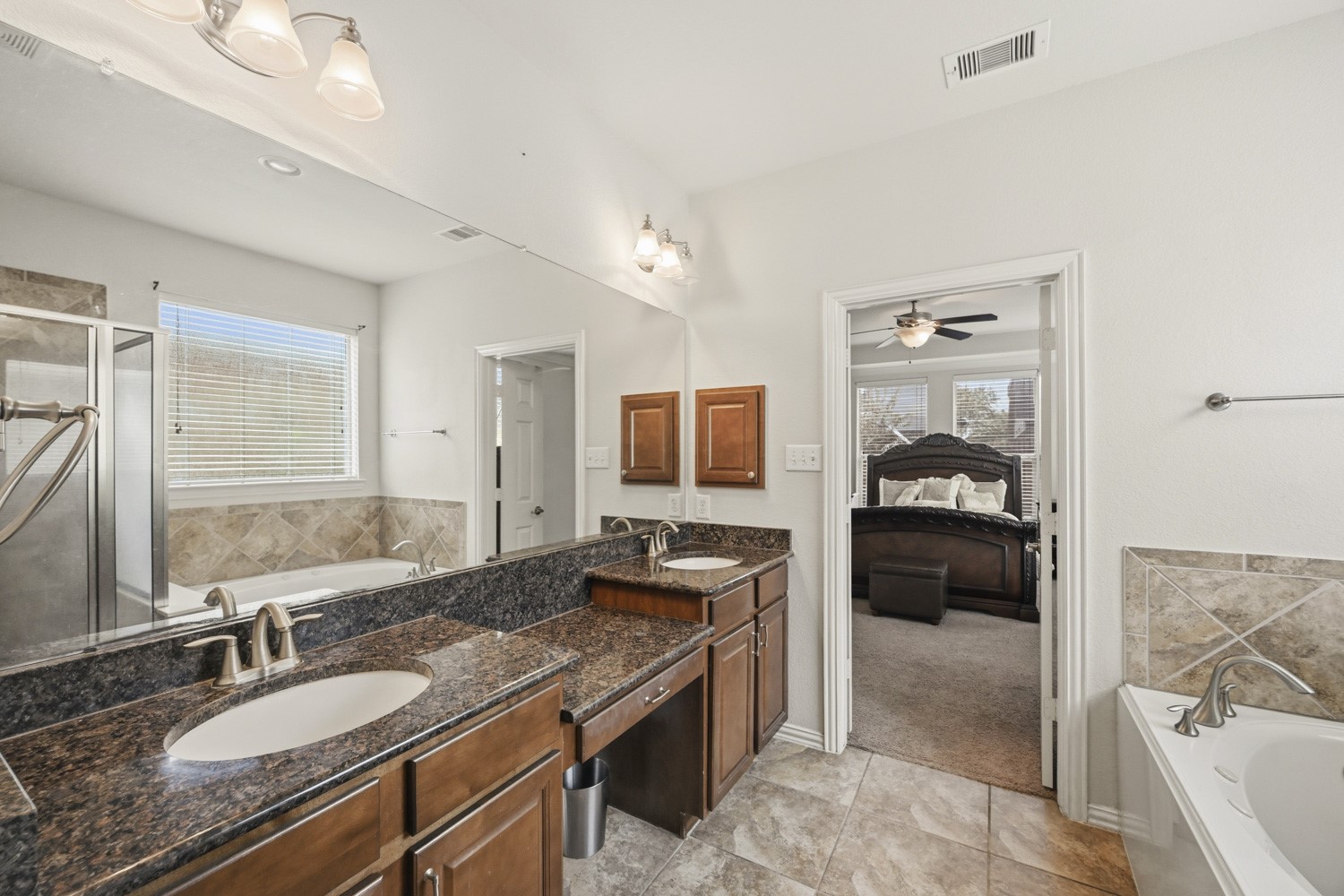 Complete with a garden tub and separate stall shower, this private ensuite connects directly to the main bedroom suite.