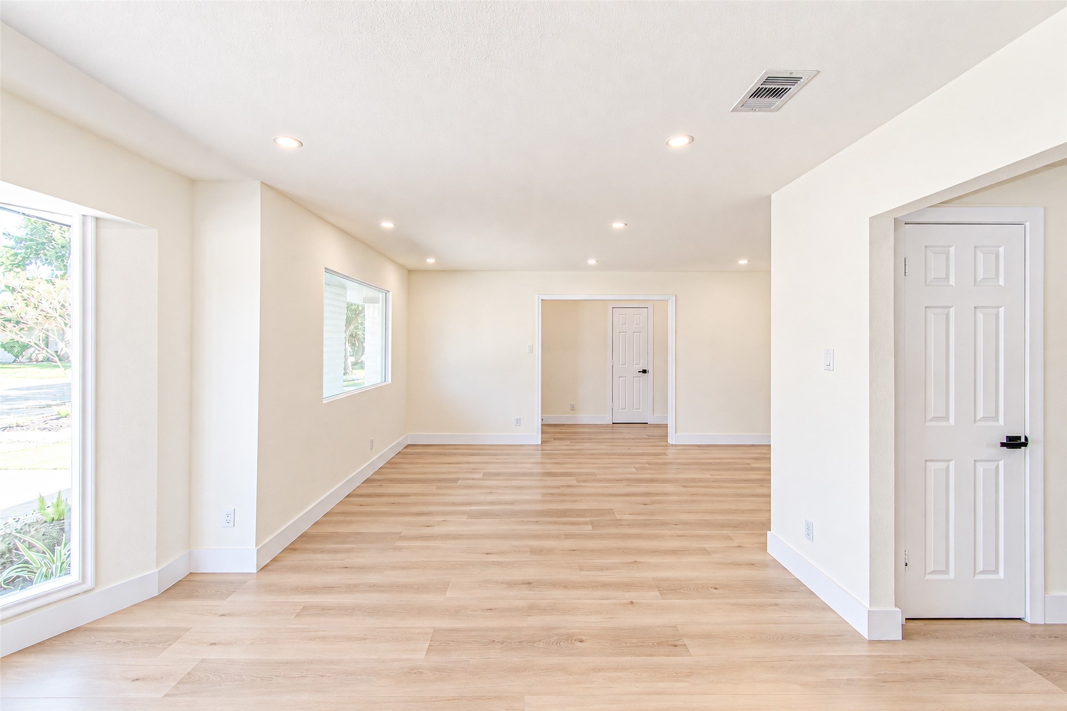 Bright and inviting, this spacious dining room boasts elegant wood flooring and floods with natural light, perfect for hosting memorable gatherings.