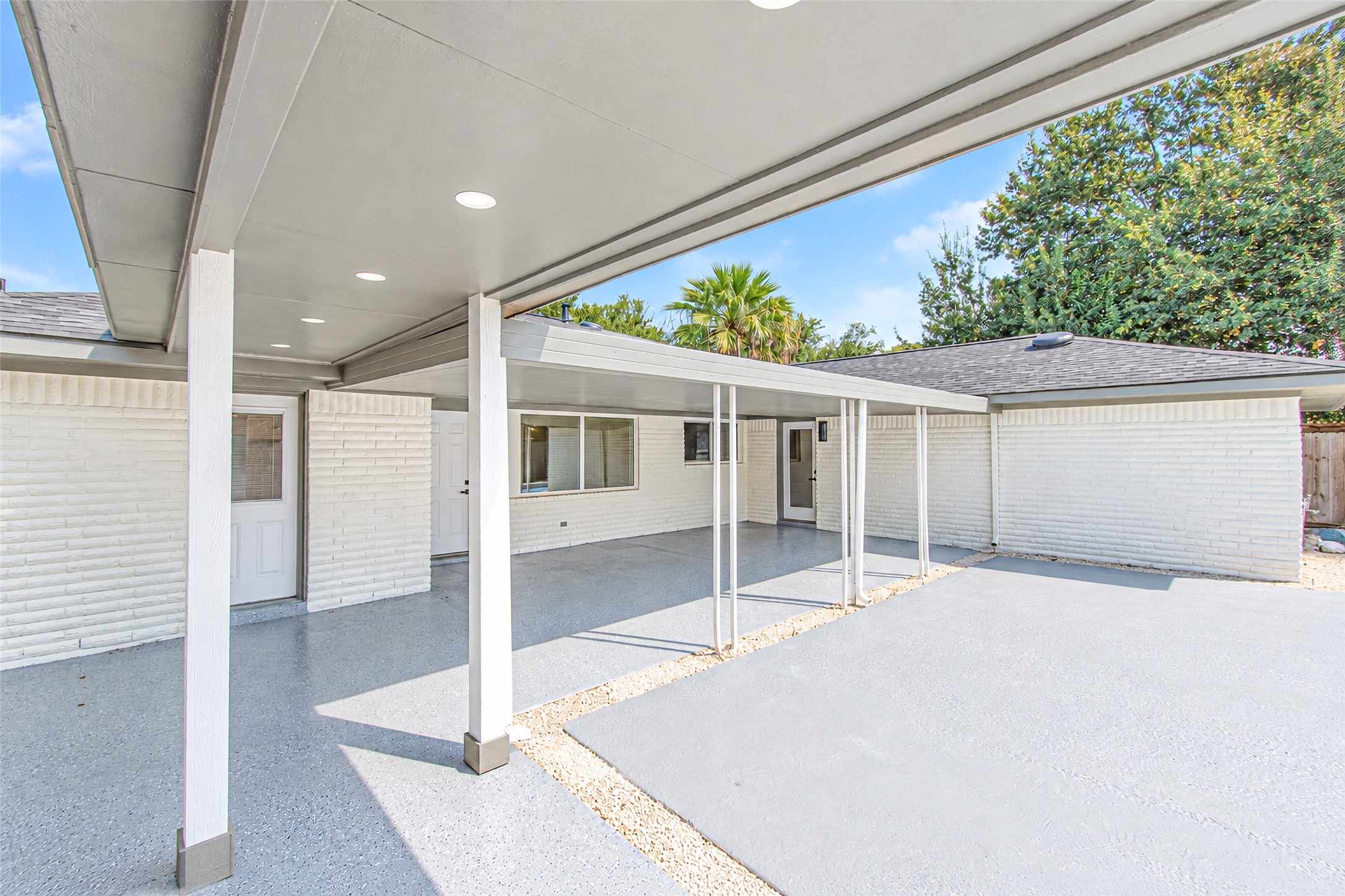 A sleek, covered breezeway seamlessly connects the garage to the home, offering both style and convenience.