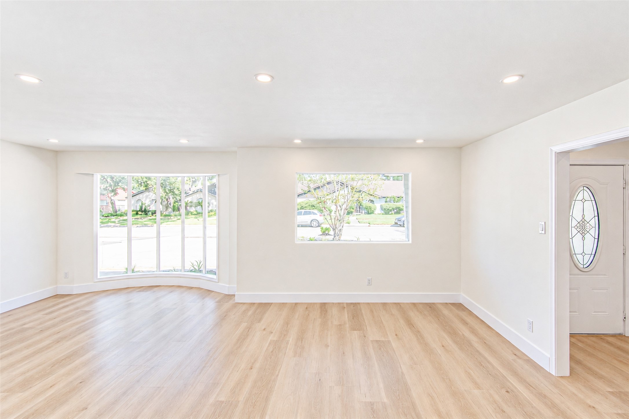 A bright and inviting space with large windows flooding the room with natural light, perfect for entertaining and creating memorable moments.