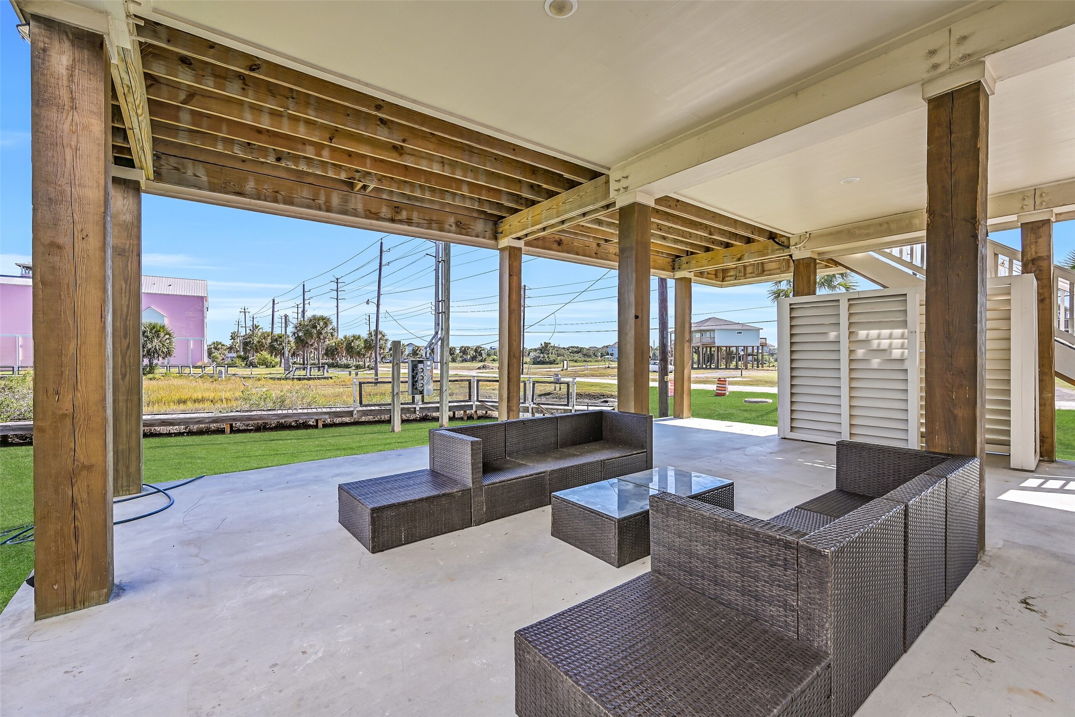 The covered ground-level area offers ample space for entertaining guests and additional parking.