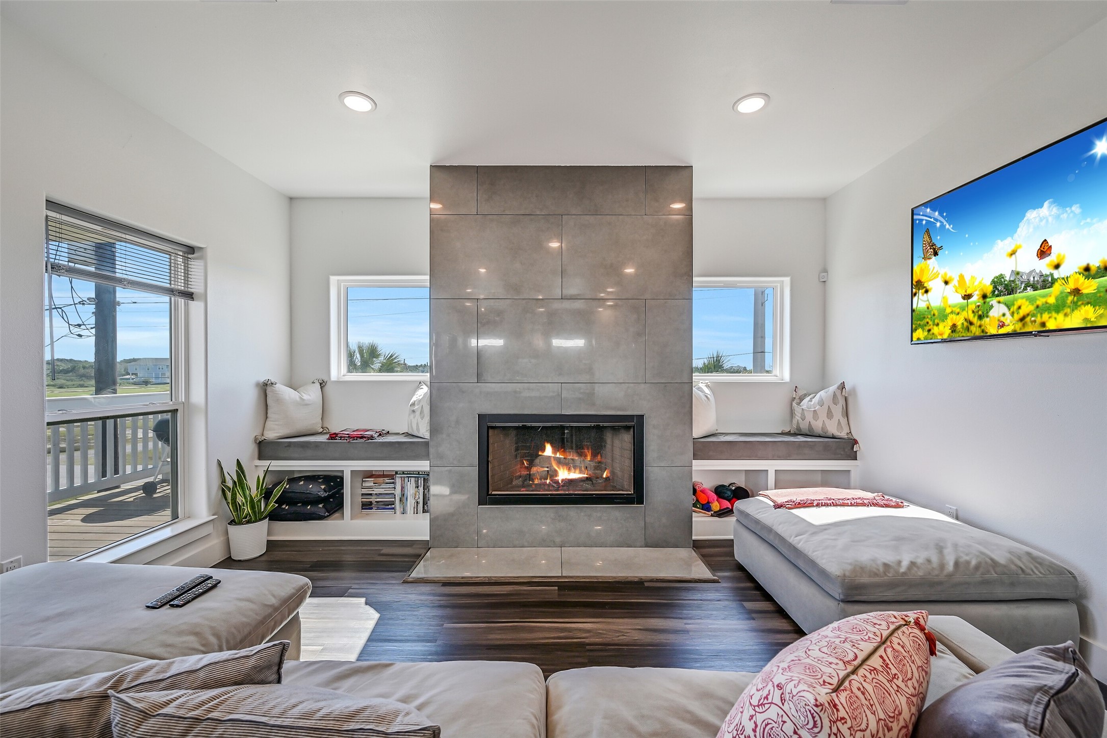 Built-in seating flanks both sides of the wood-burning fireplace, adding charm and functionality to the living space.