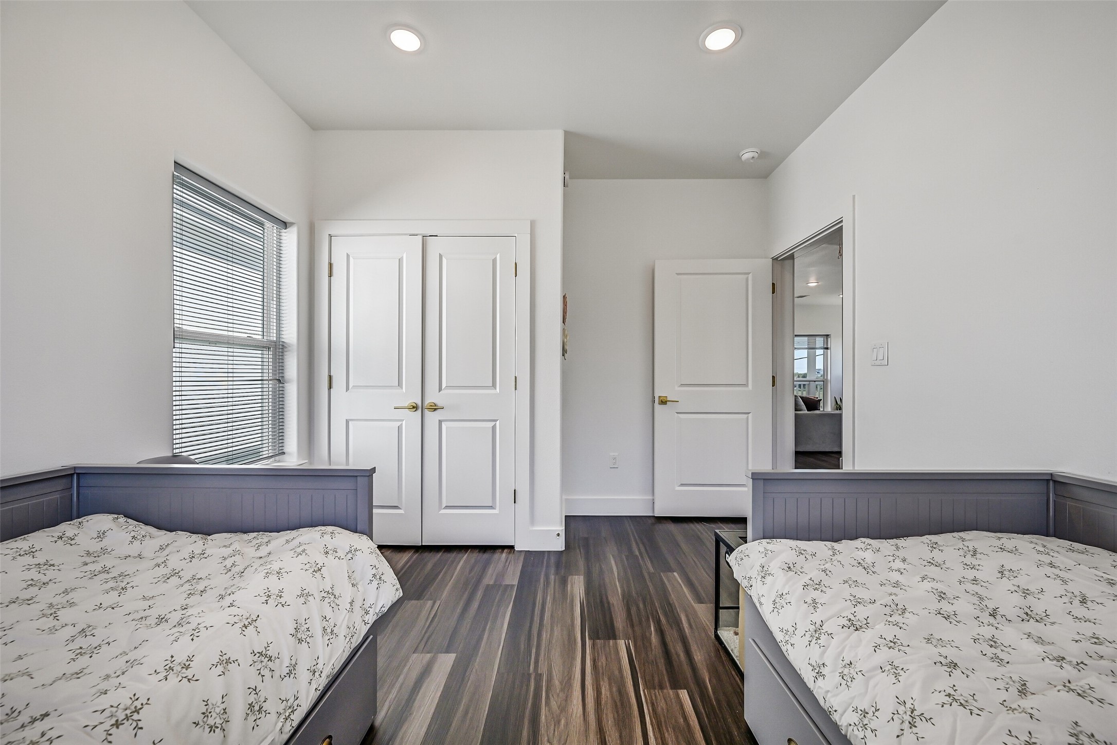 The guest bedroom offers a spacious closet and currently accommodates two twin beds.