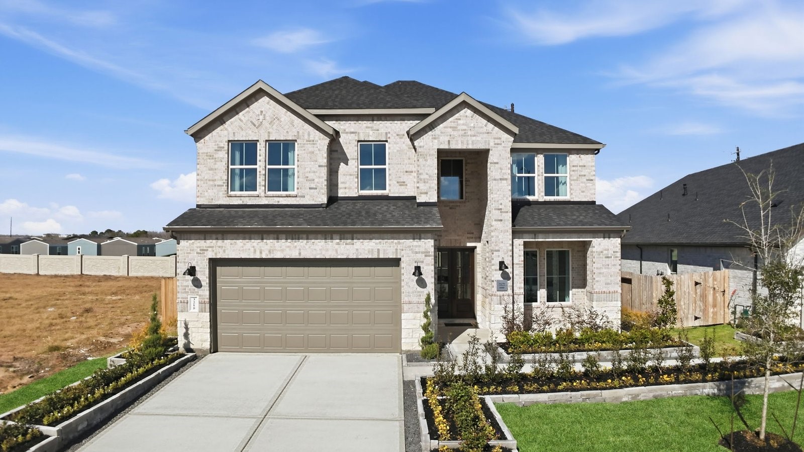 A beautiful spacious two story home with modern interior architecture, a covered patio, four bedrooms, three and a half bathrooms and a three car garage