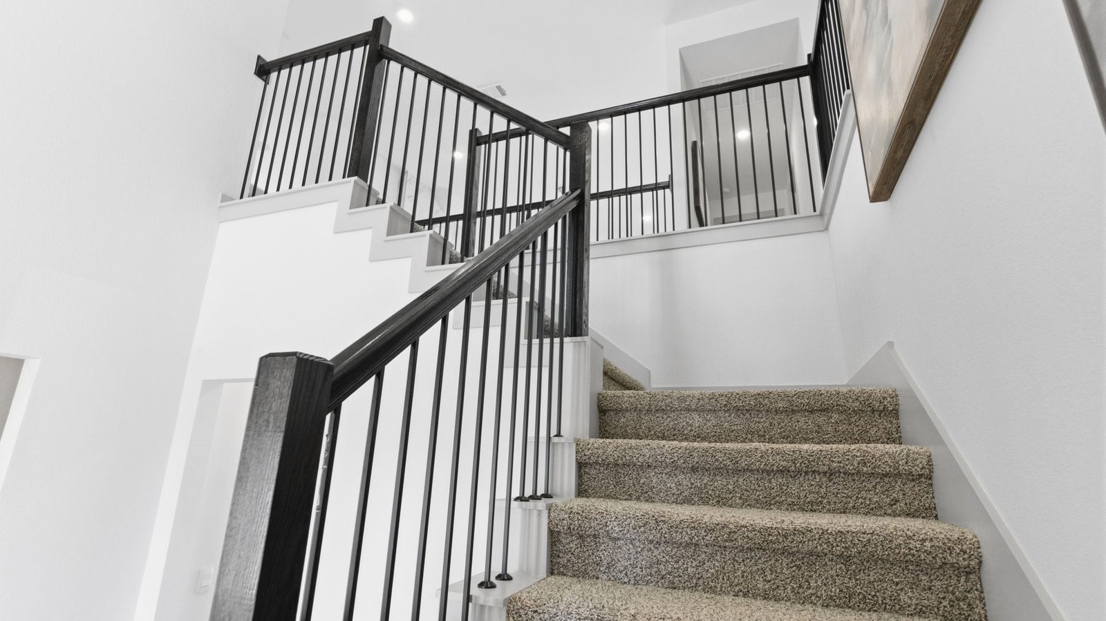A grand staircase leading to the second floor with a luminating chandelier