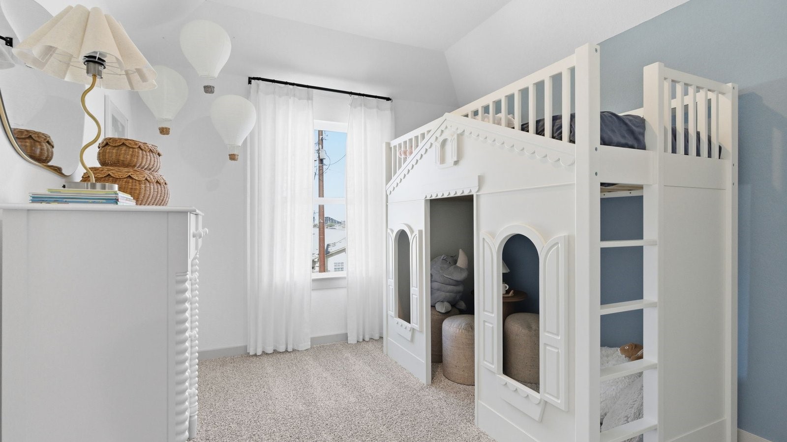A vibrant bedroom showcasing a neatly made bed, a stylish dresser, and a playful painting that adds charm.