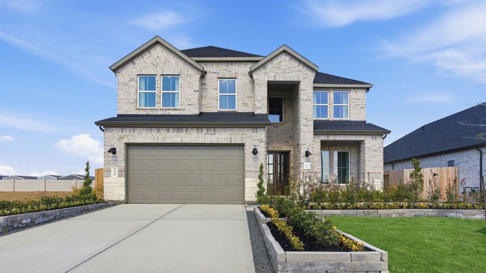 A beautiful spacious two story home with modern interior architecture, a covered patio, four bedrooms, three and a half bathrooms and a three car garage