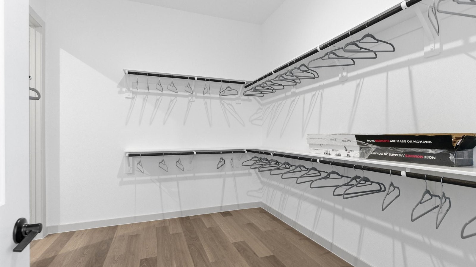 The primary walk-in closet with two rows of shelves and rods for maximum storage opportunities