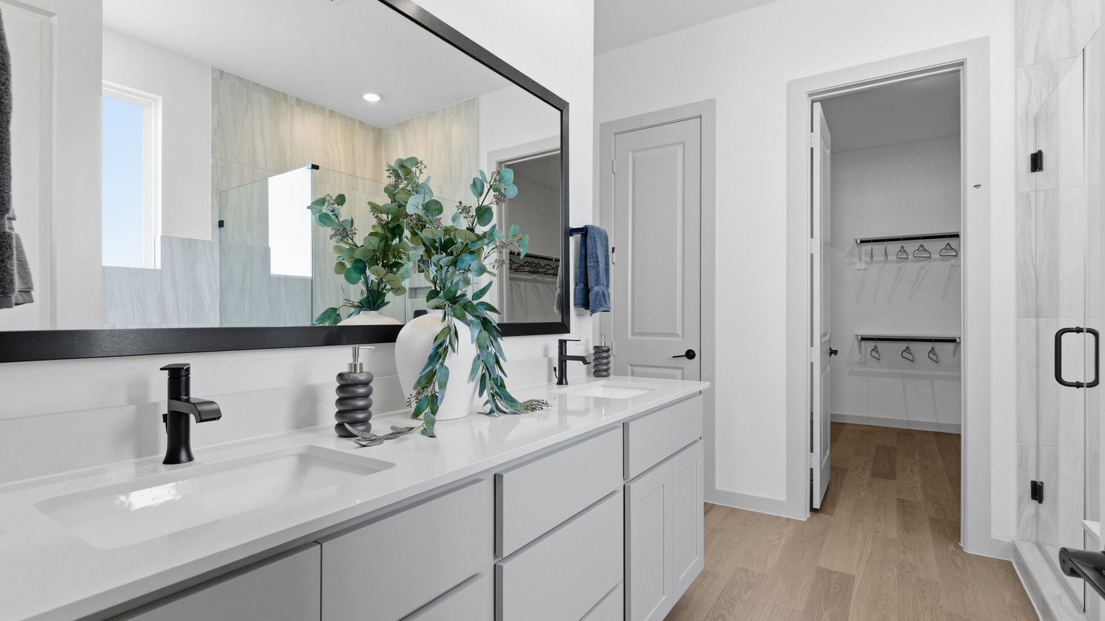 Primary bathroom with a glass-enclosed standing shower and separate soaking tub.