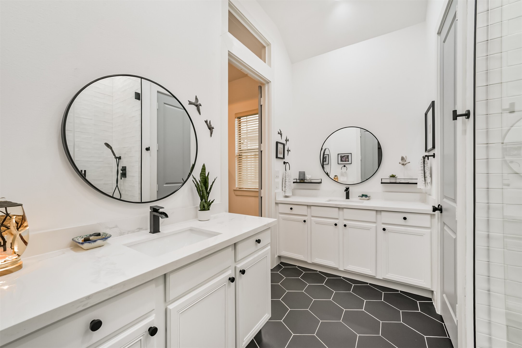 Double sinks in primary bathroom with gorgeous hexagonal tile floors!
