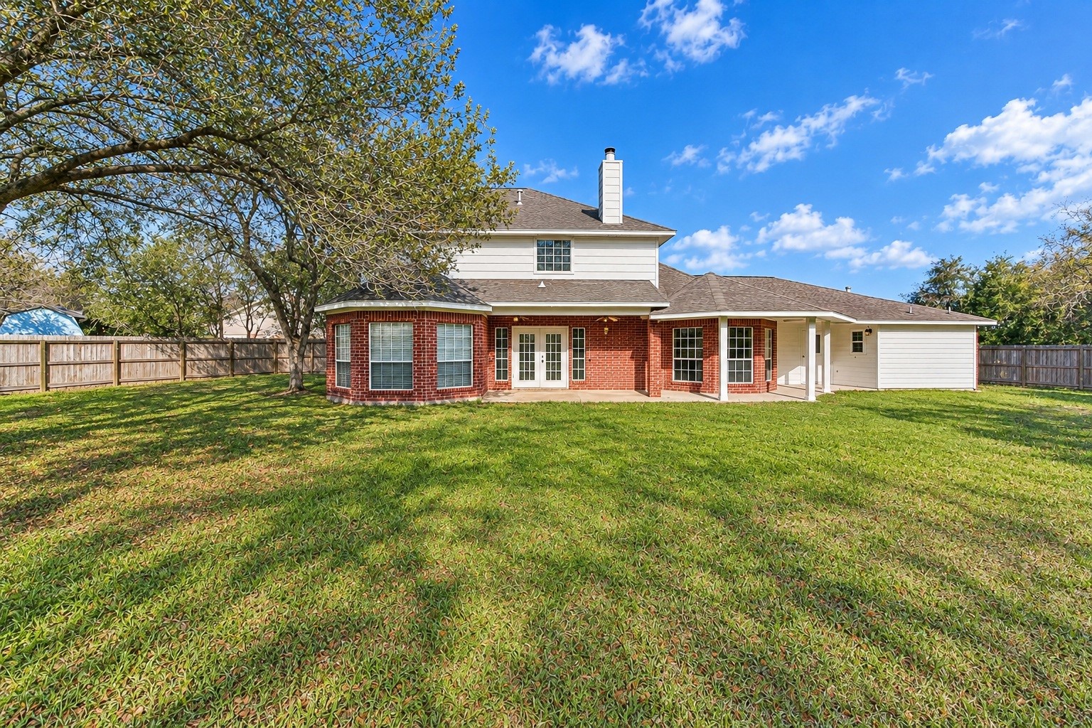 Charming home with a stylish brick exterior and a welcoming covered walkway, perfect for enjoying the outdoors.