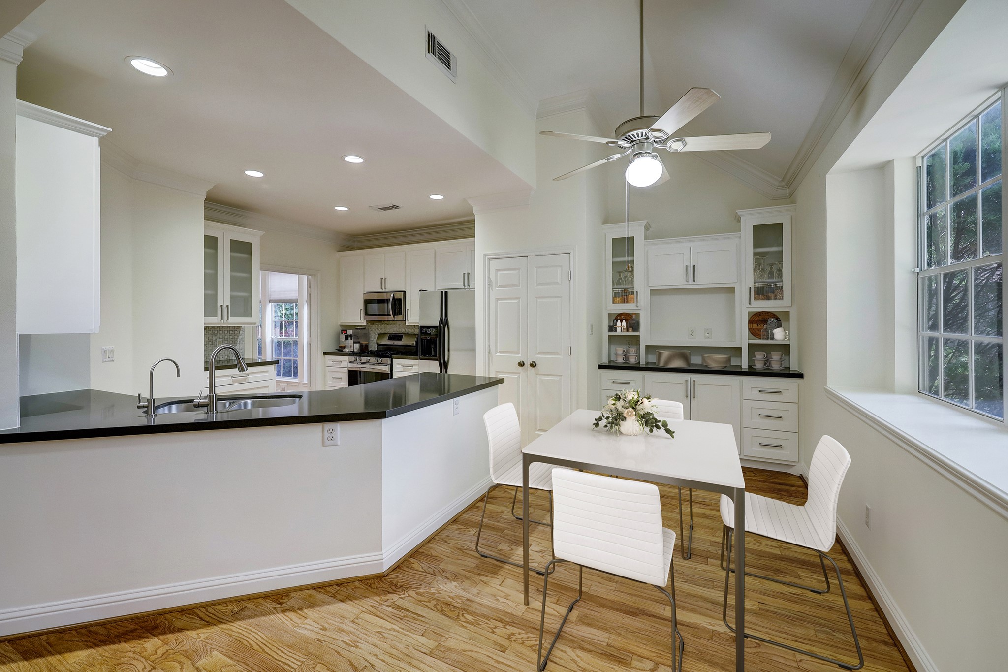 Kitchen & Breakfast Area: Bright and modern space featuring stainless steel appliances, granite countertops, and hardwood flooring. Virtual staging showcases layout potential and design inspiration.