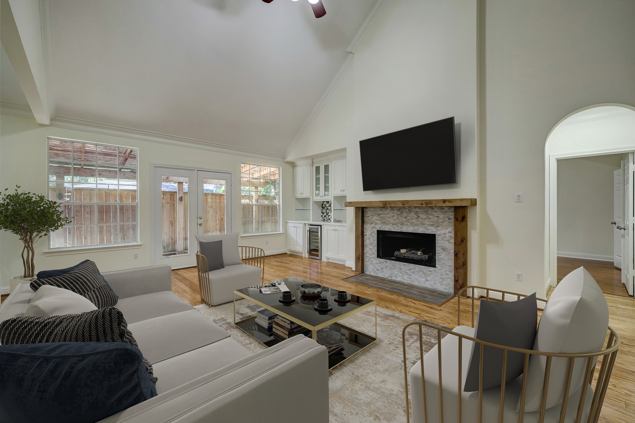 Living Room: Spacious and bright with high ceilings, hardwood floors, and a cozy fireplace. French doors and large windows bring in natural light, while virtual staging highlights the rooms potential for stylish and comfortable living. Virtually Staged