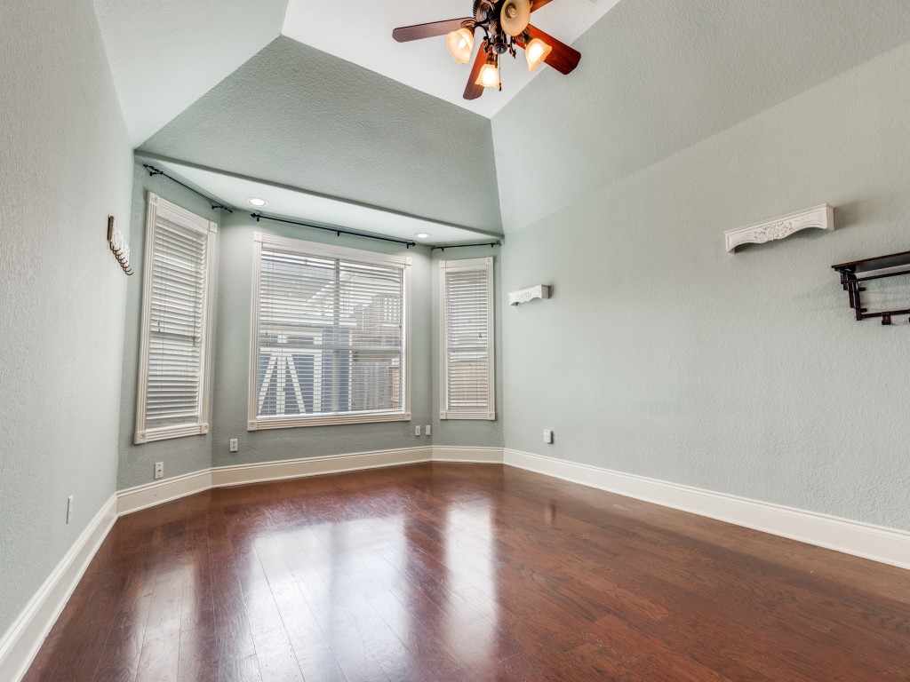 Bright primary room with large windows and a vaulted ceiling. Space is large enough to have a sitting area by the windows.