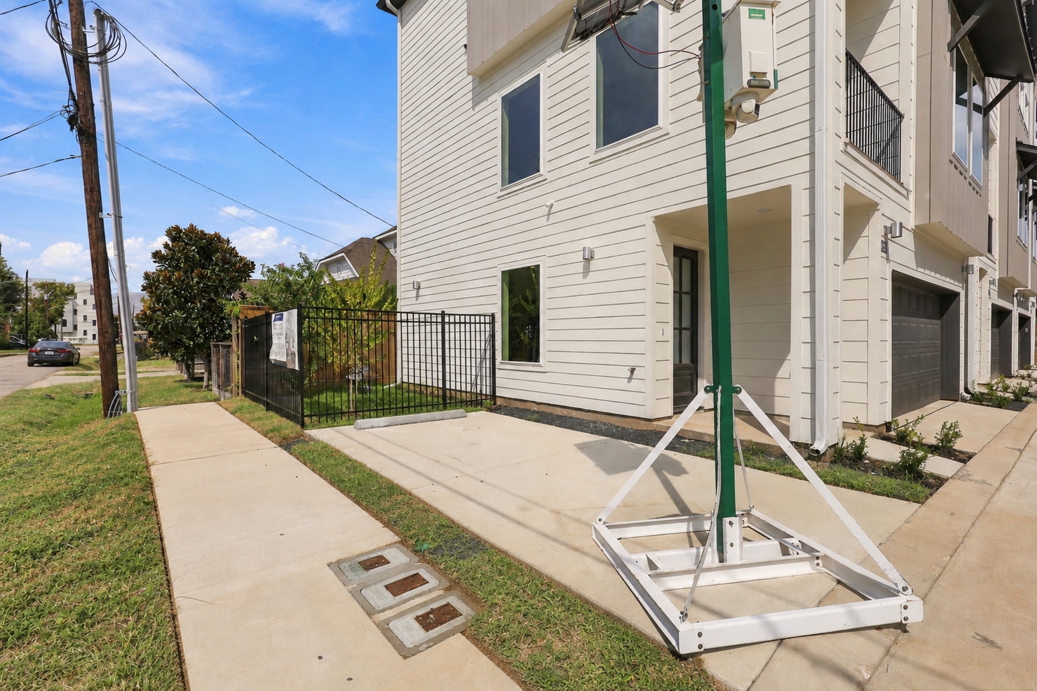 The side view shows the yard and additional parking beside the garage.