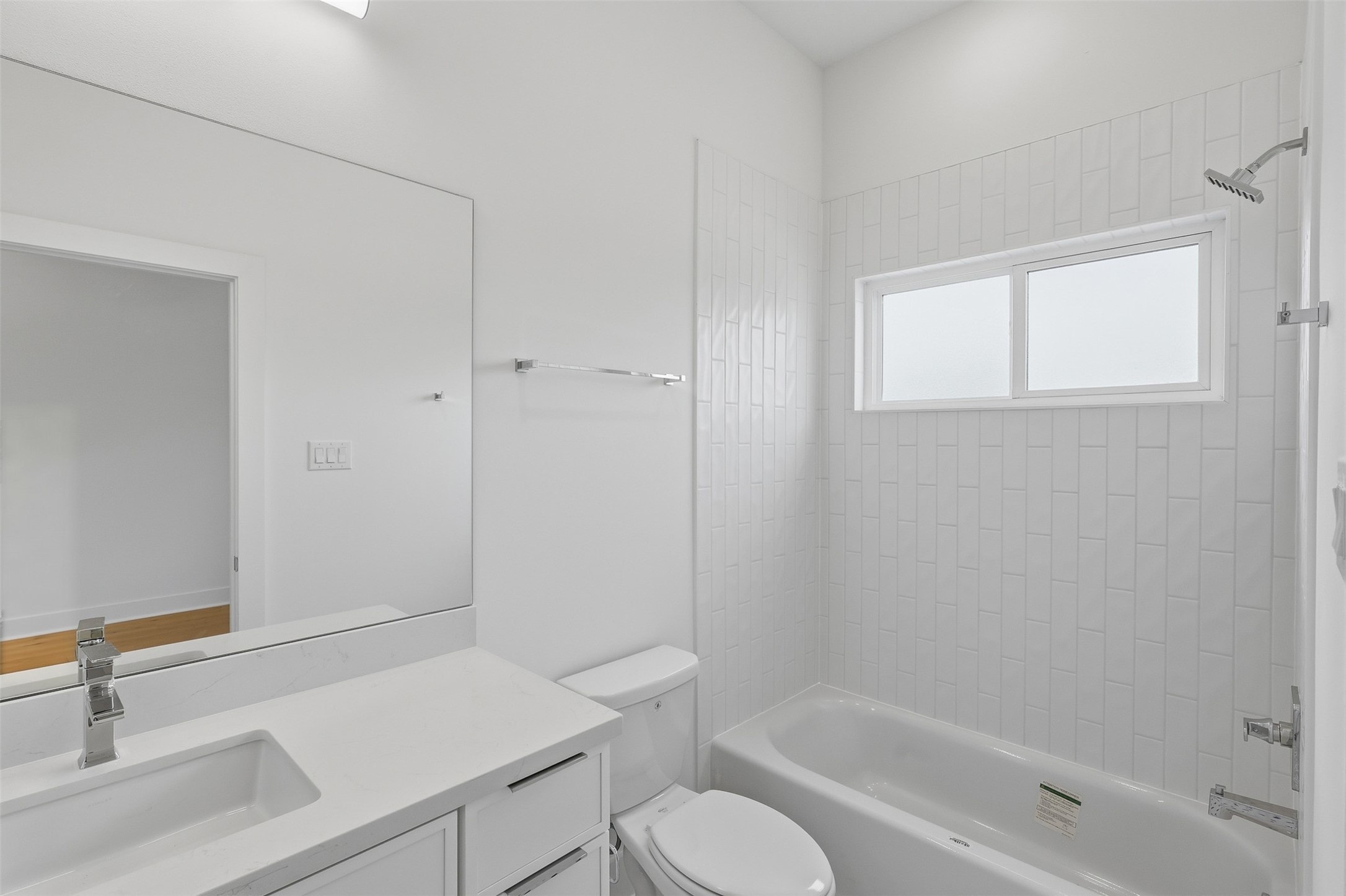 The laundry space includes appliance connections and shelving.