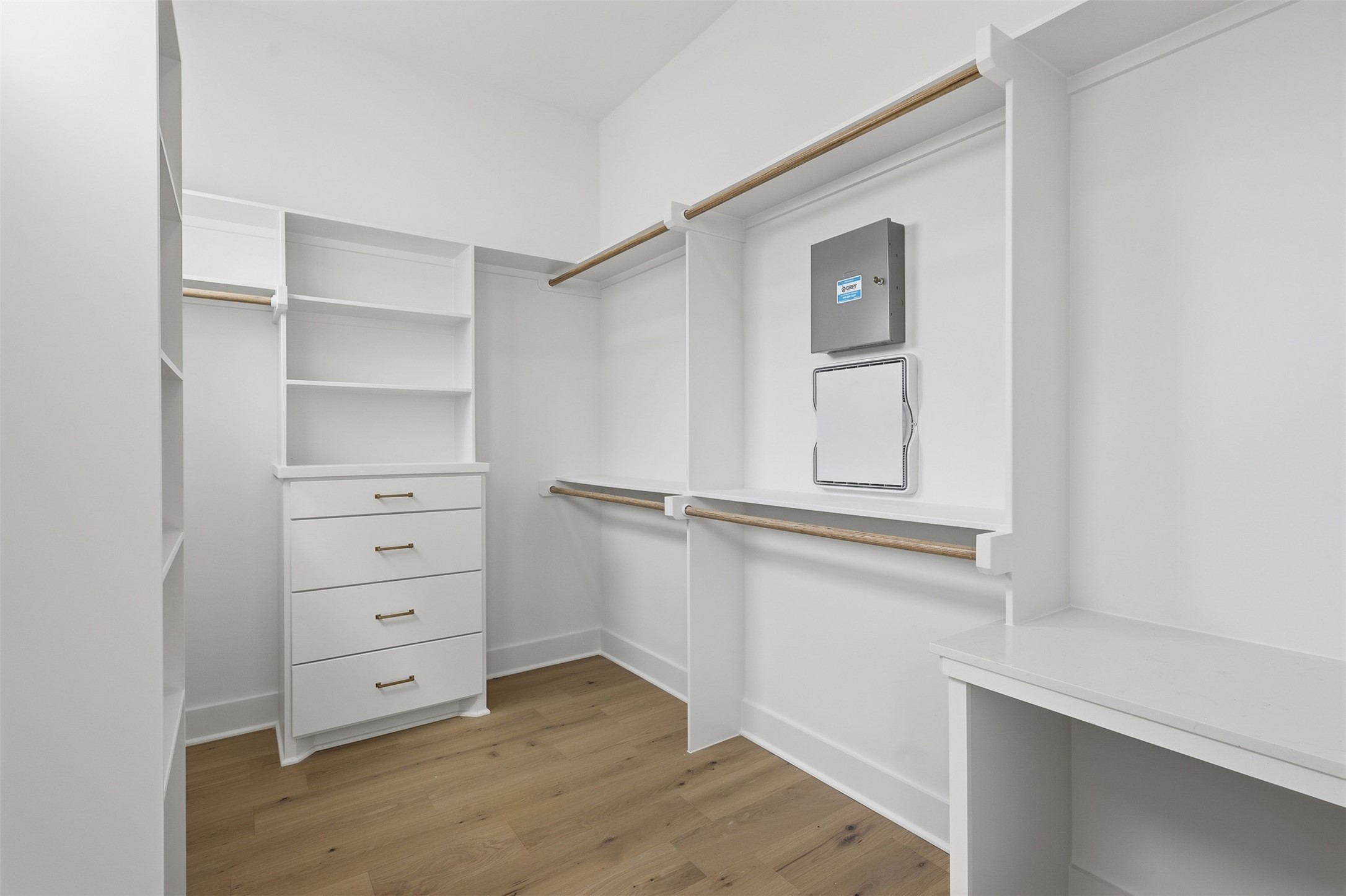The walk-in closet keeps clothing organized with drawers, shelves, and hanging space.