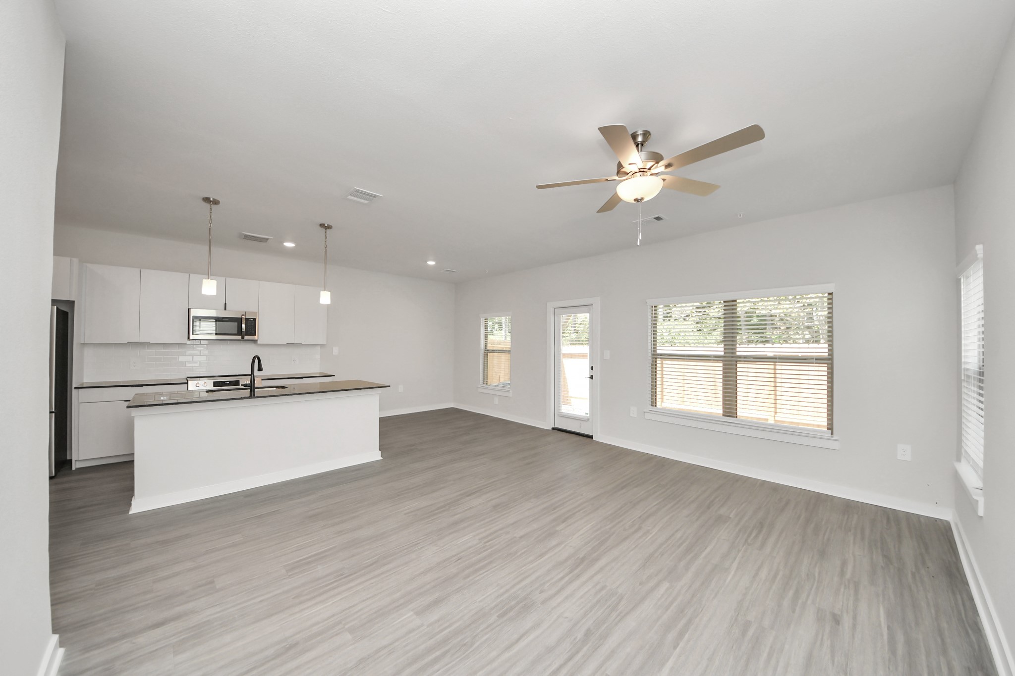 Boasting luxury finishes-stylish Island kitchen,granite counters,subway tile backsplash,ample custom cabinet space,stainless appliances,refrigerator,full size washer&dryer included,wood-like floors throughout,open concept floor plan.
