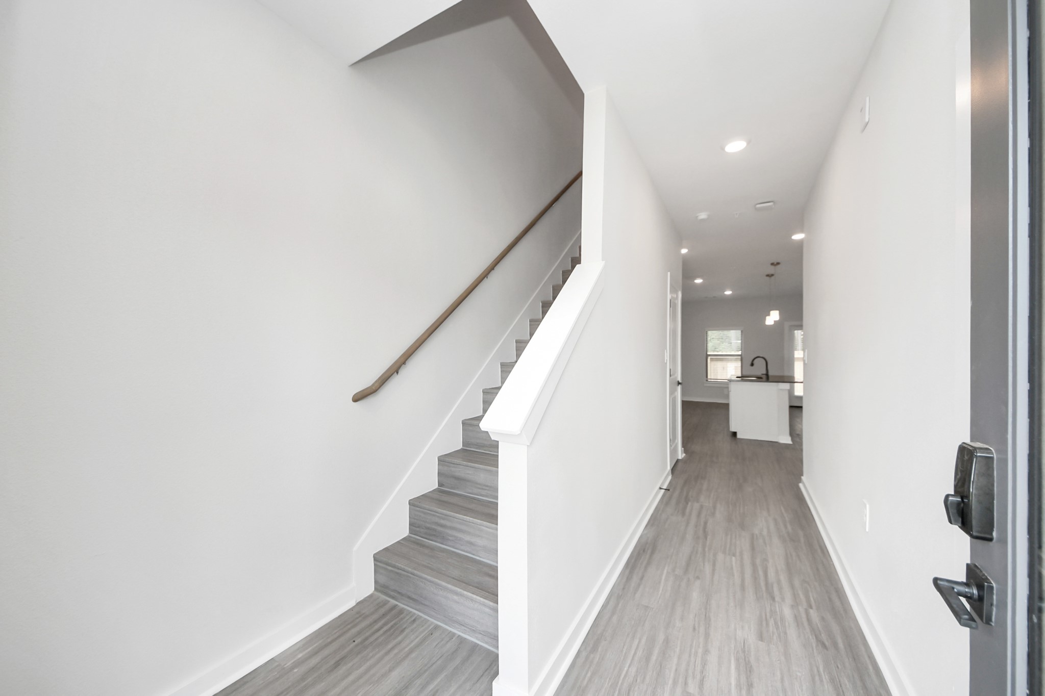 Boasting luxury finishes-stylish Island kitchen,granite counters,subway tile backsplash,ample custom cabinet space,stainless appliances,refrigerator,full size washer&dryer included,wood-like floors throughout,open concept floor plan.