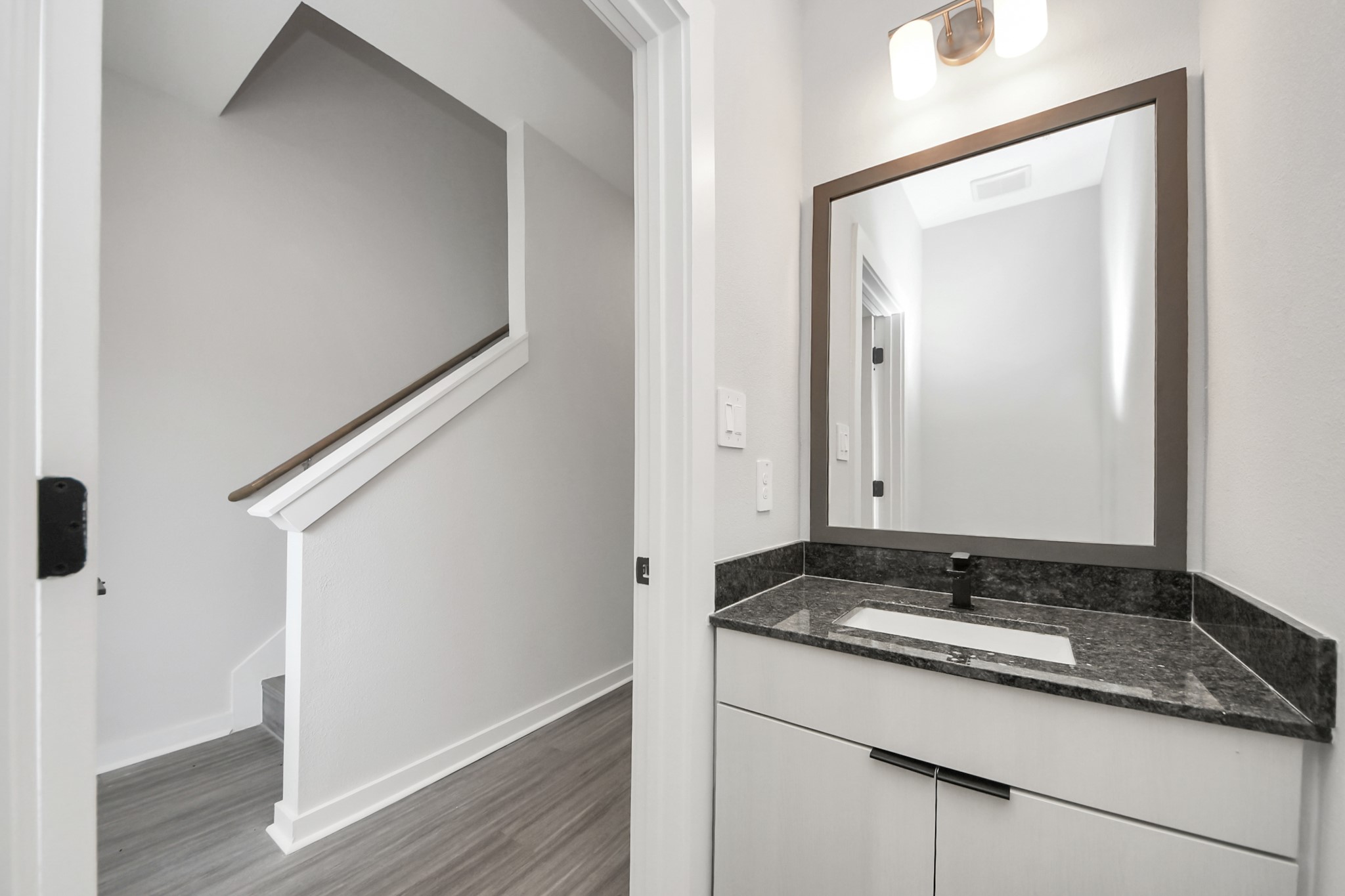 Half Bathroom with granite vanity.