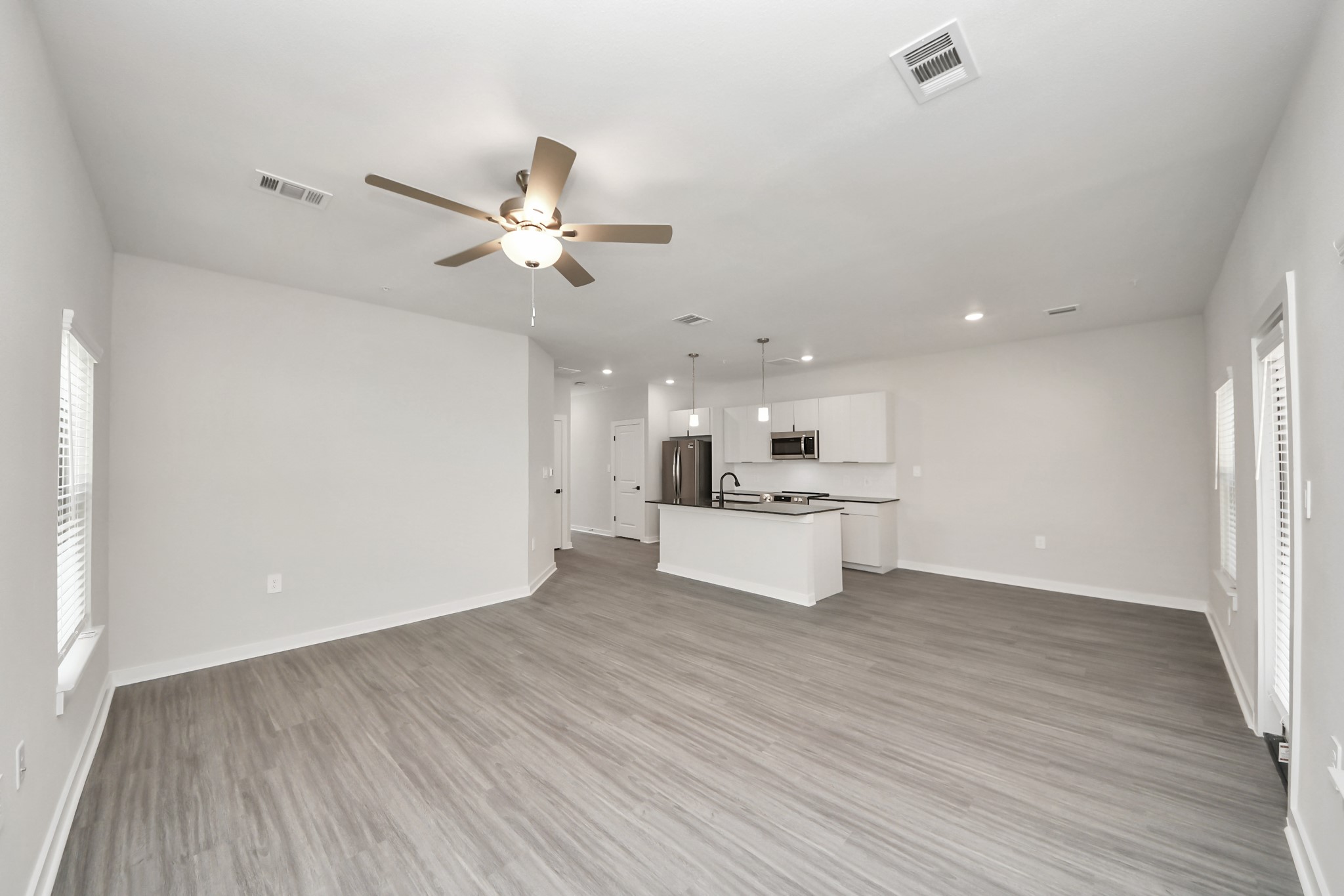 Boasting luxury finishes-stylish Island kitchen,granite counters,subway tile backsplash,ample custom cabinet space,stainless appliances,refrigerator,full size washer&dryer included,wood-like floors throughout,open concept floor plan.