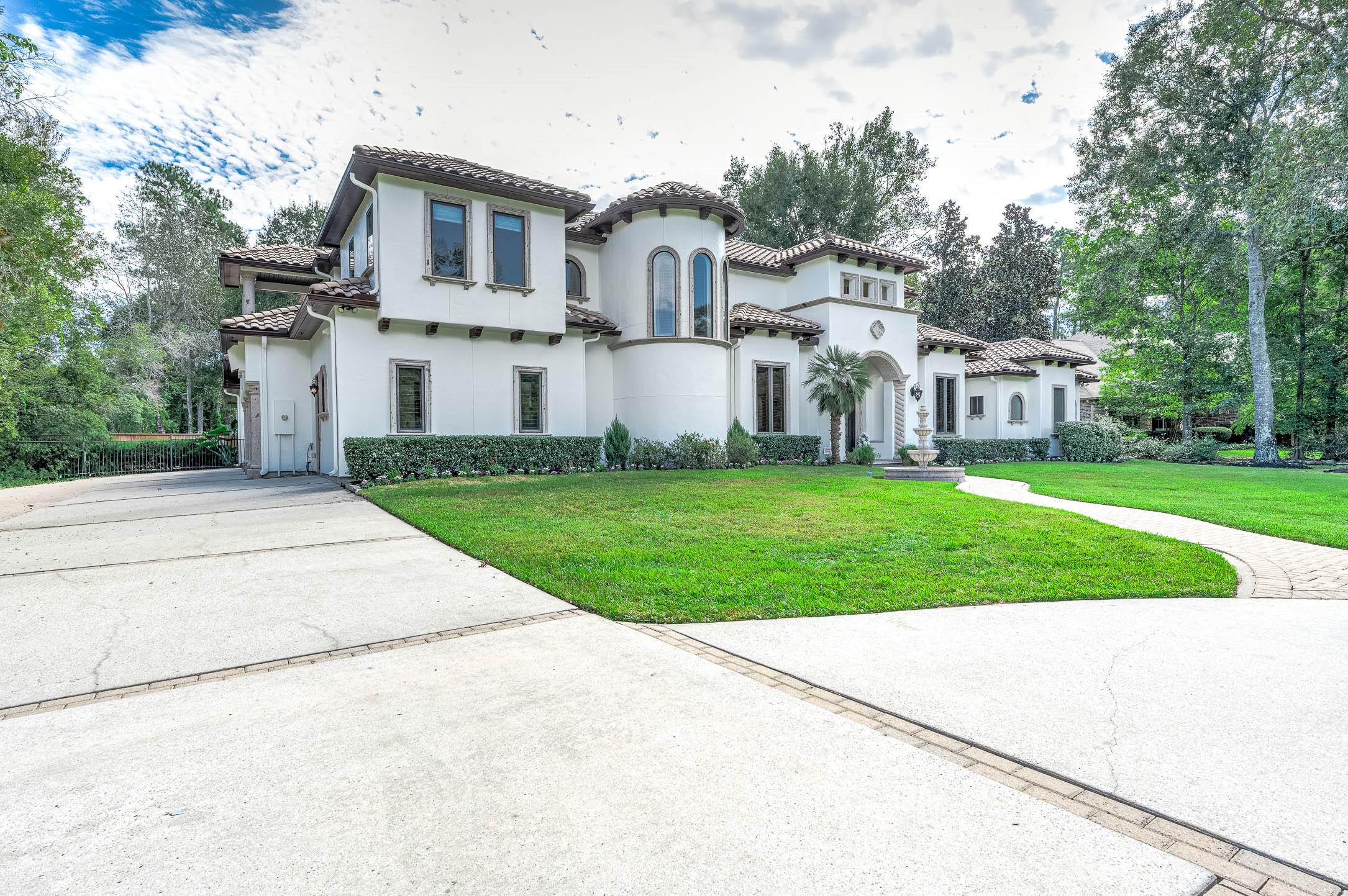 Set on a 1.10-acre cul-de-sac lot, the home is framed by large mature trees and a sweeping private driveway.