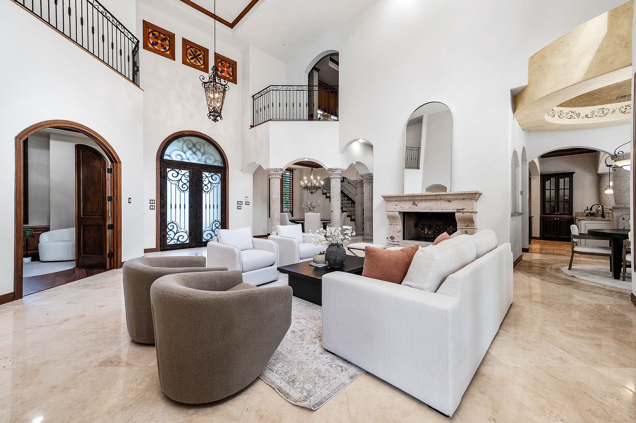 A carved stone fireplace anchors the formal living room, one of three fireplaces in the home.