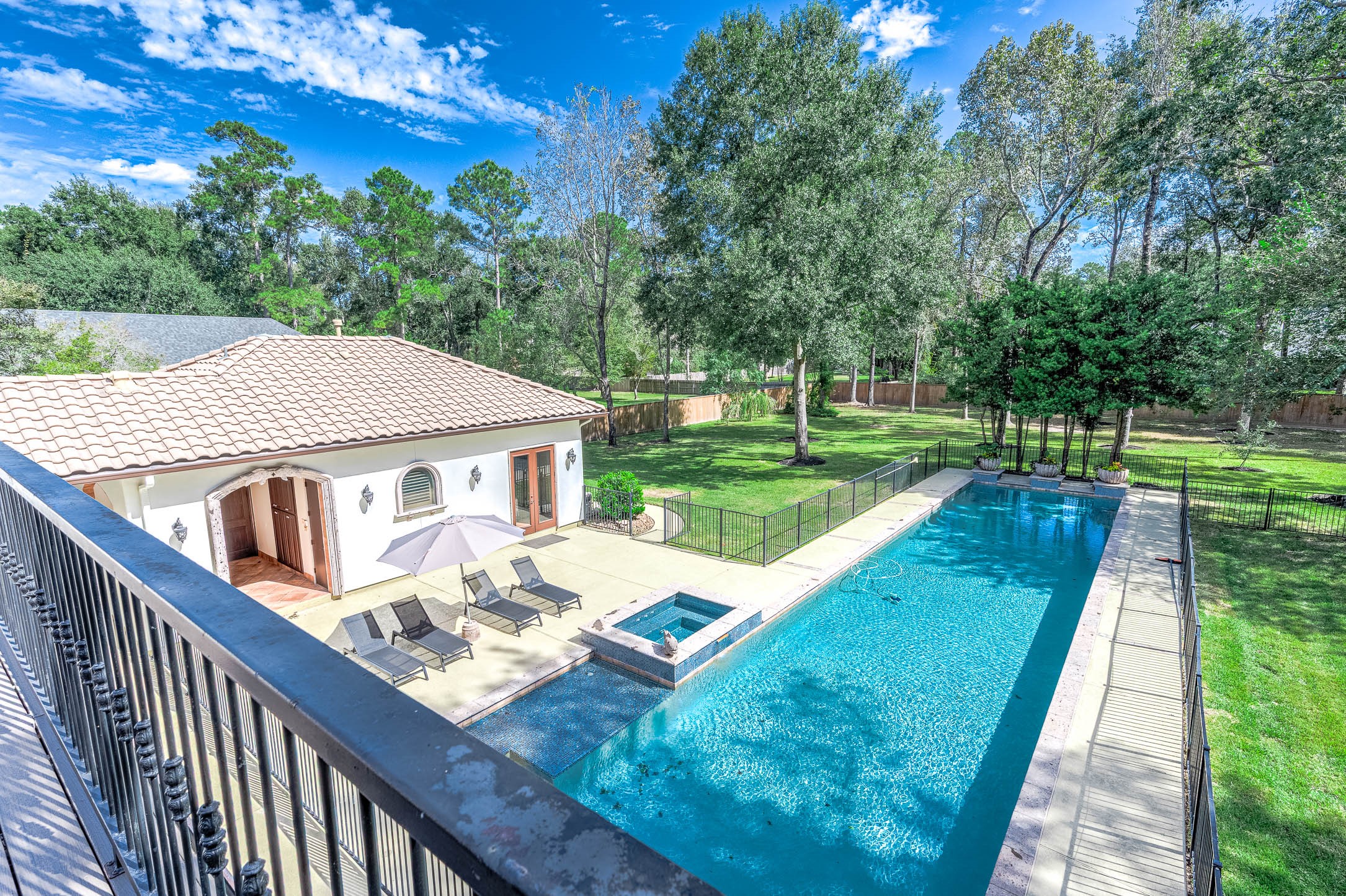 The resort-style backyard offers detached guest quarters alongside the pool and spacious pool deck.
