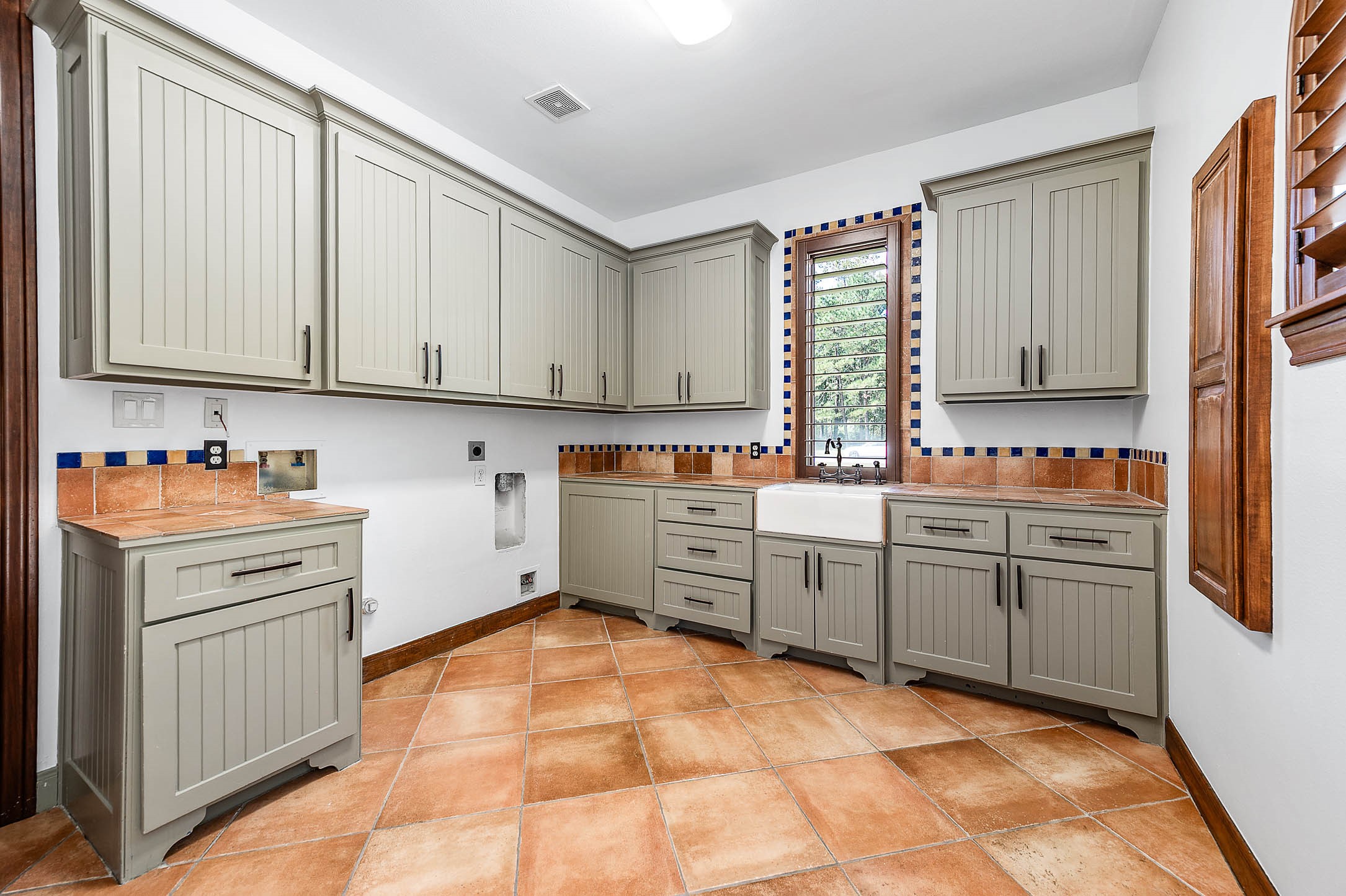 Large utility room with custom cabinetry.