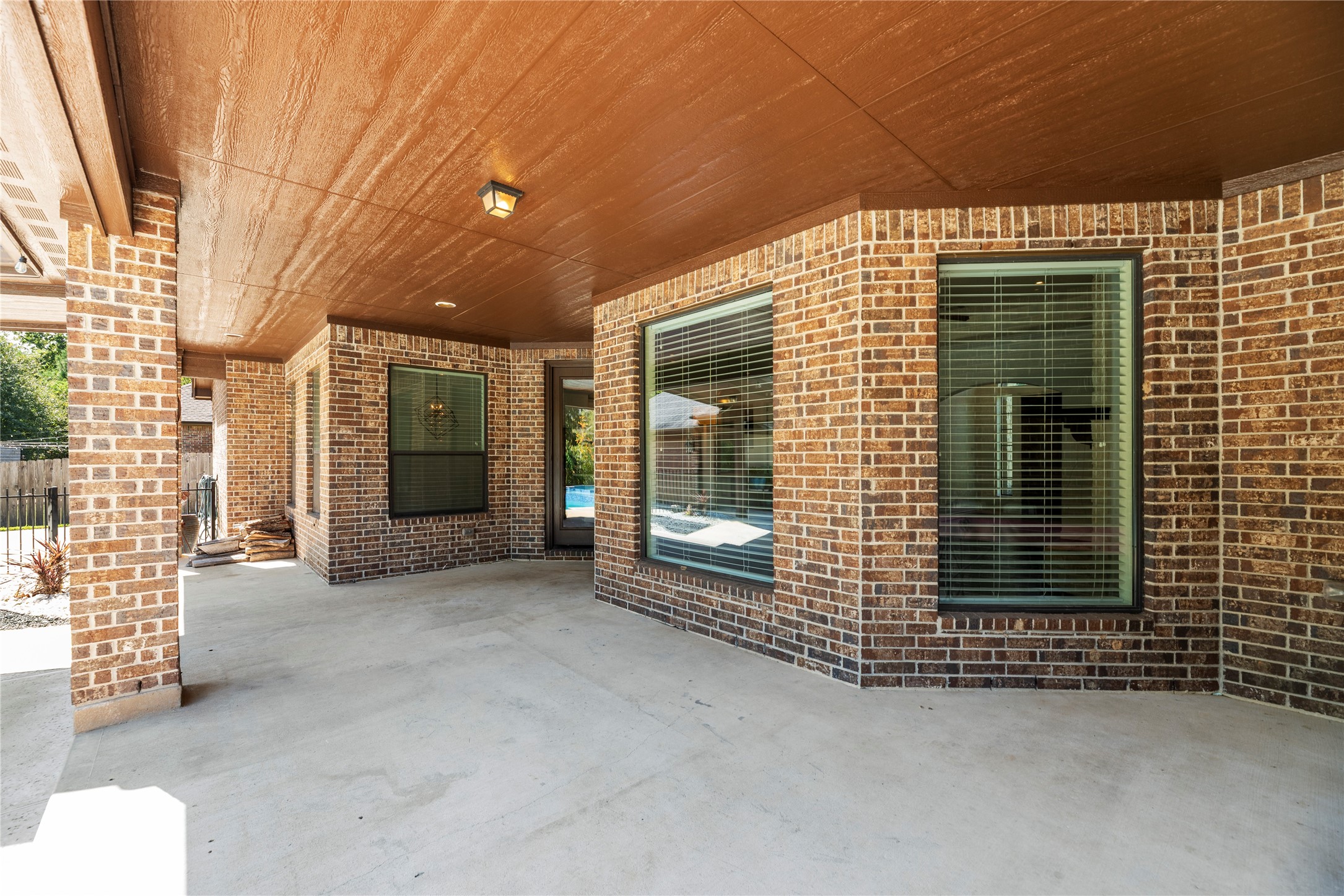 Extended covered patio has plenty of room to create a beautiful outdoor seating and dining area overlooking the backyard.