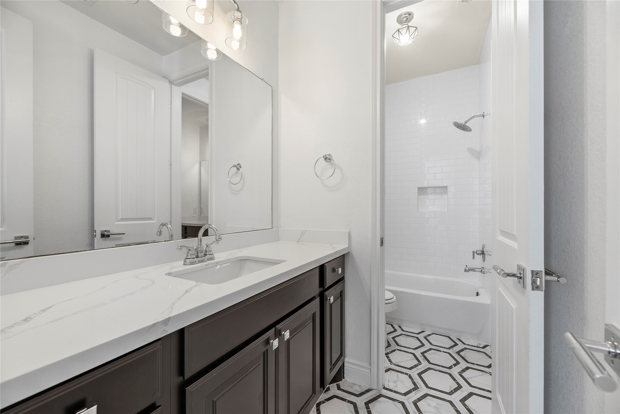 Jack 'n Jill bathroom with 2 vanities and a tub/shower combination.