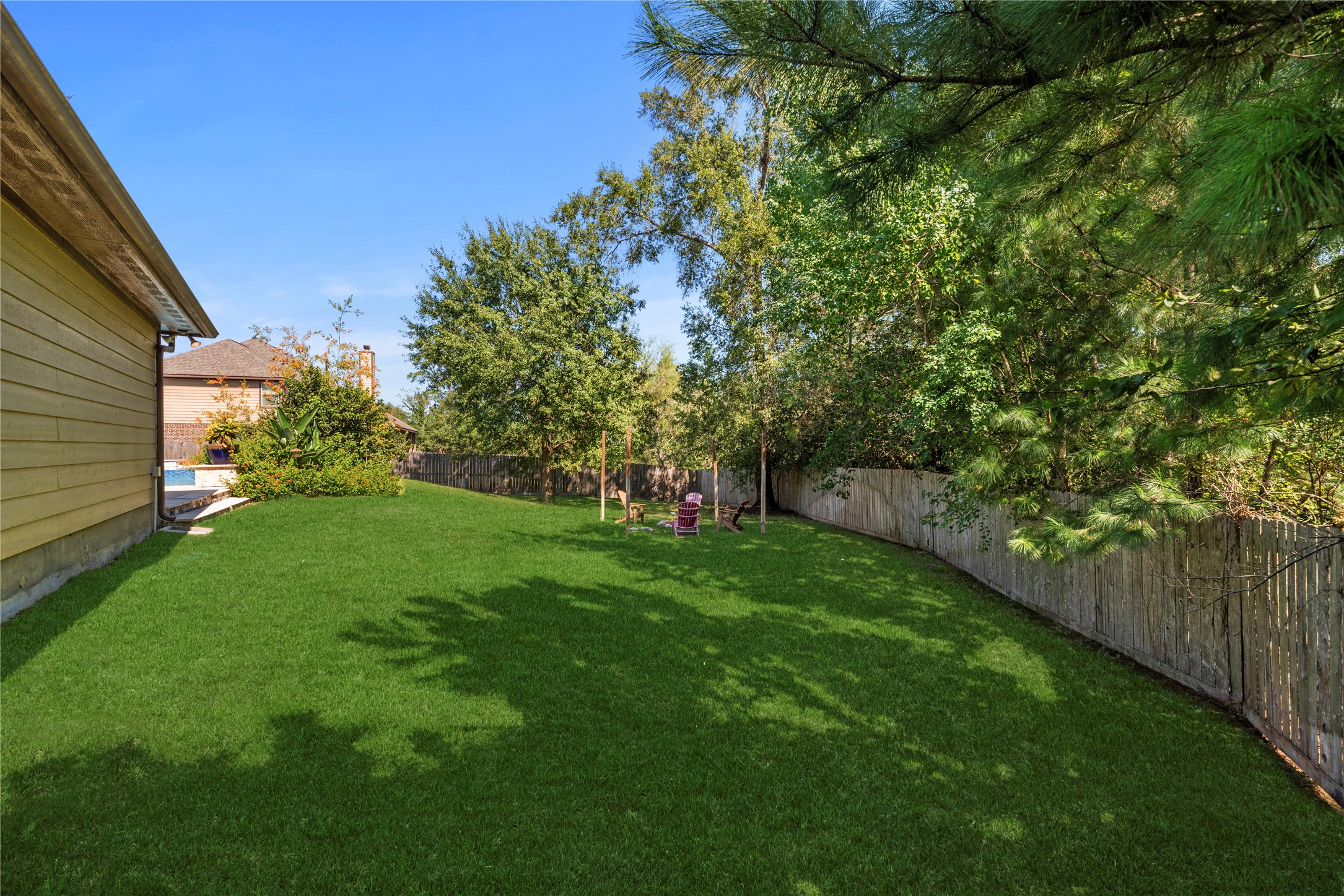 Plenty of green space behind the pool.
