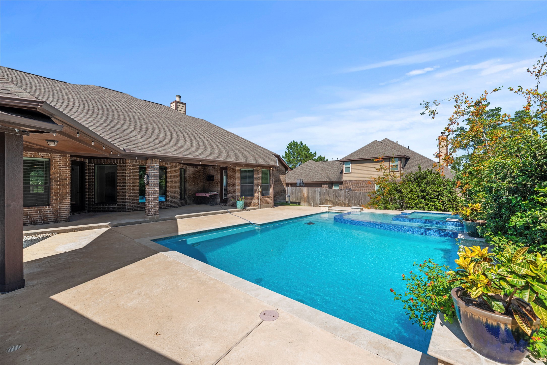 Step outside to an amazing backyard with a refreshing pool/spa and covered patio.