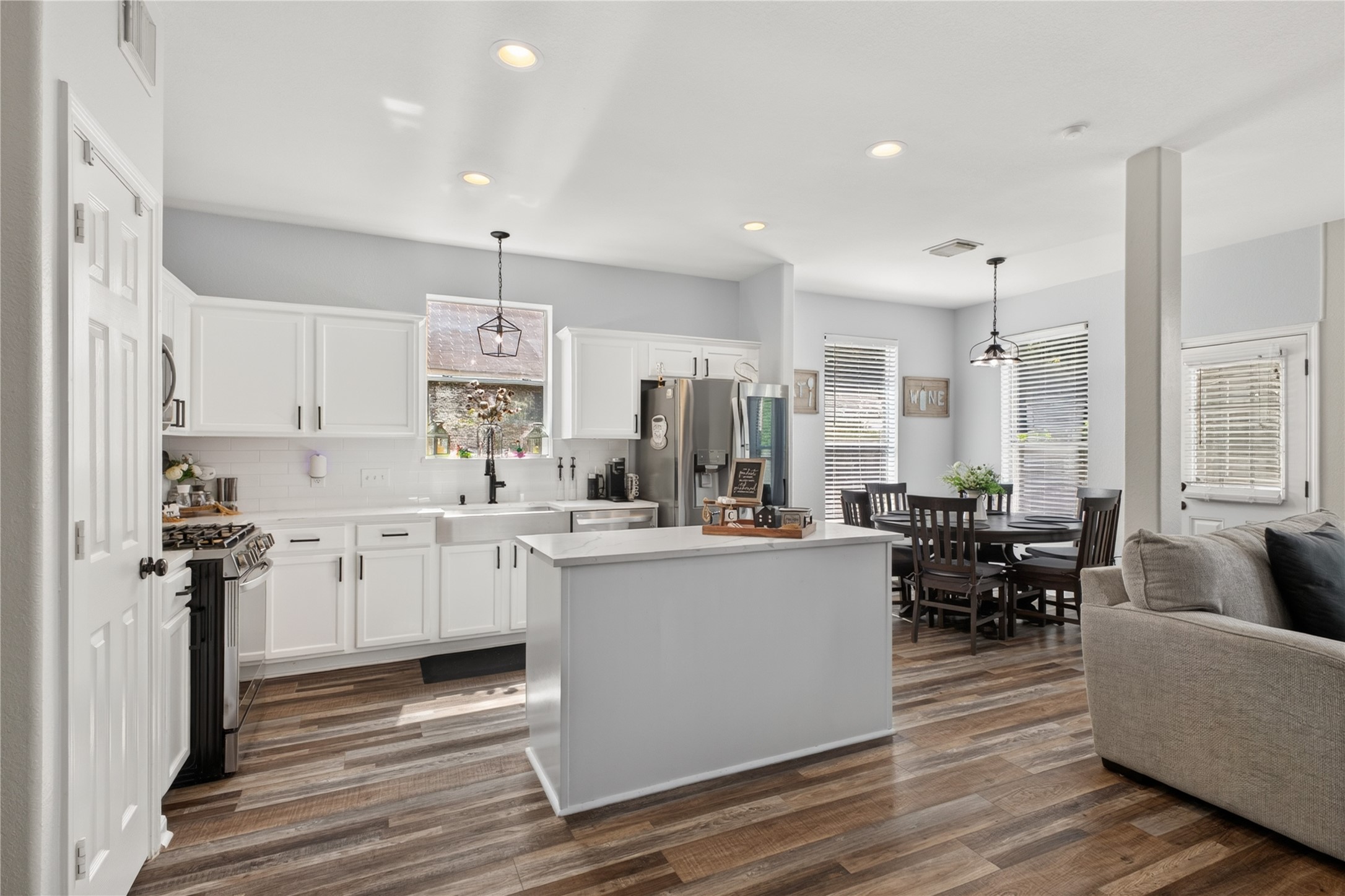 Gorgeous updated kitchen with quartz countertops, island and farmhouse sink