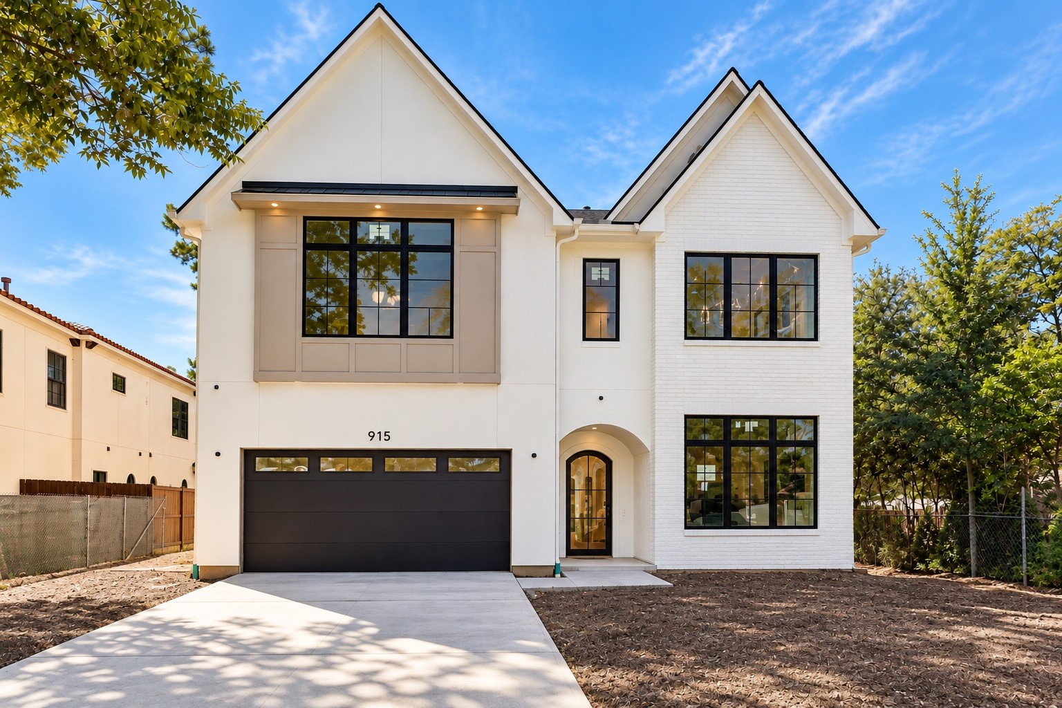 White painted brick will unify the exterior, highlighting steep gables, black framed windows and a welcoming arched entry. Digitally enhanced image illustrates the future finish; the existing brick is currently unpainted and will be painted white. White painted brick will unify the exterior, highlighting steep gables, black framed windows and a welcoming arched entry. Digitally enhanced image illustrates the future finish; the existing brick is currently unpainted and will be painted white.