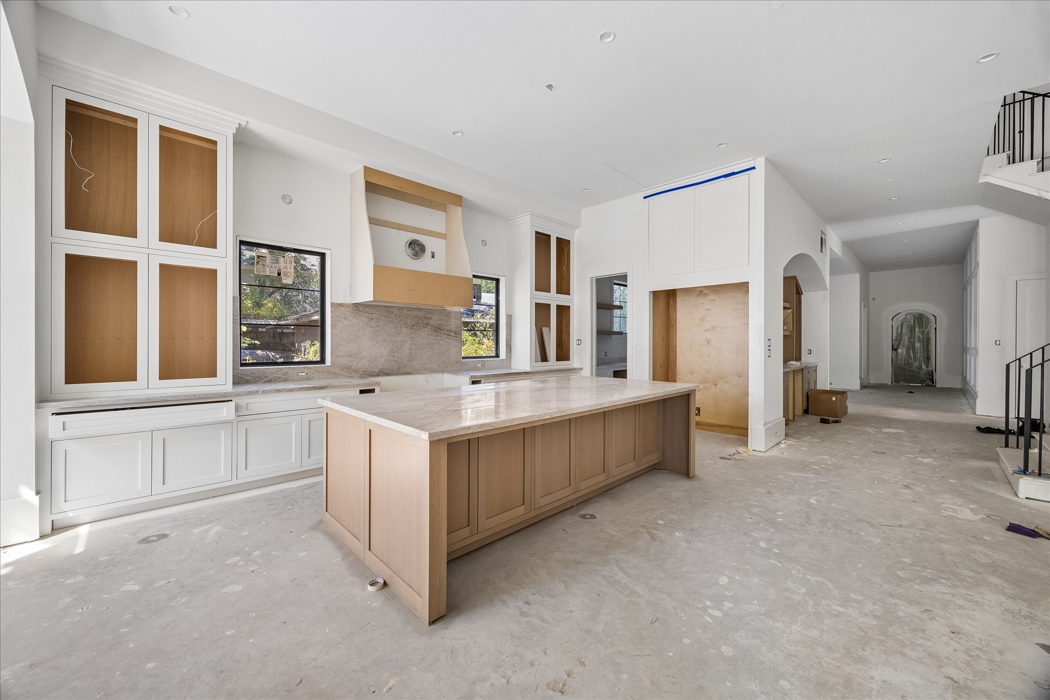 10 x 5 island anchors the kitchen with a broad preparation surface and storage on multiple sides. Selected 2 cm Taj Mahal quartzite brings natural veining to the kitchen and bar counters, paired here with natural tone island cabinetry and painted perimeter cabinets. 10 x 5 island anchors the kitchen with a broad preparation surface and storage on multiple sides. Selected 2 cm Taj Mahal quartzite brings natural veining to the kitchen and bar counters, paired here with natural tone island cabinetry and painted perimeter cabinets.