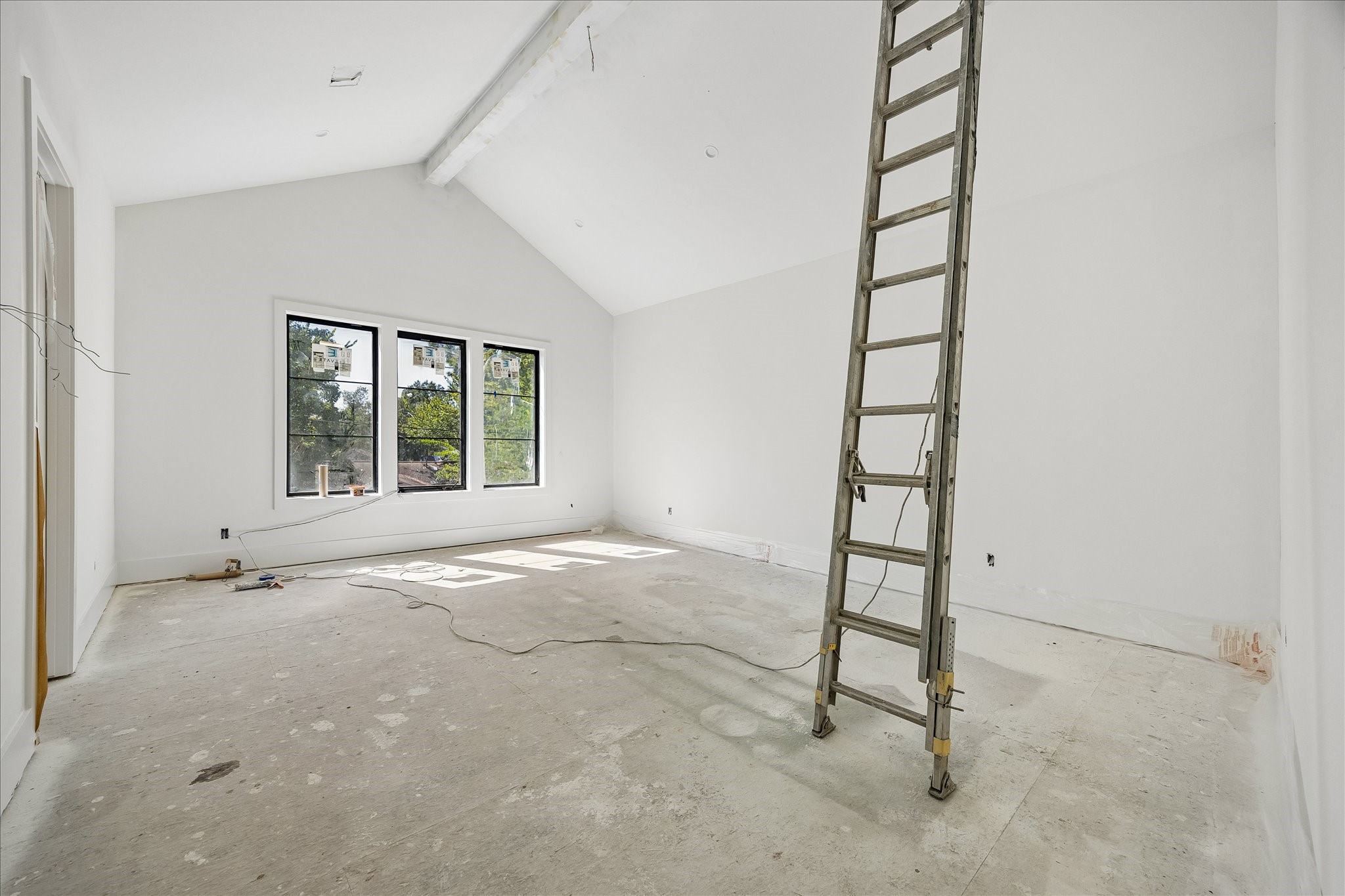 Vaulted ceiling lines rise above a bank of 3 windows, bringing height and daylight to this upper level room. Black window frames contrast with the light walls and trim. Builder window specifications call for dual pane Low E casement units. Vaulted ceiling lines rise above a bank of 3 windows, bringing height and daylight to this upper level room. Black window frames contrast with the light walls and trim. Builder window specifications call for dual pane Low E casement units.