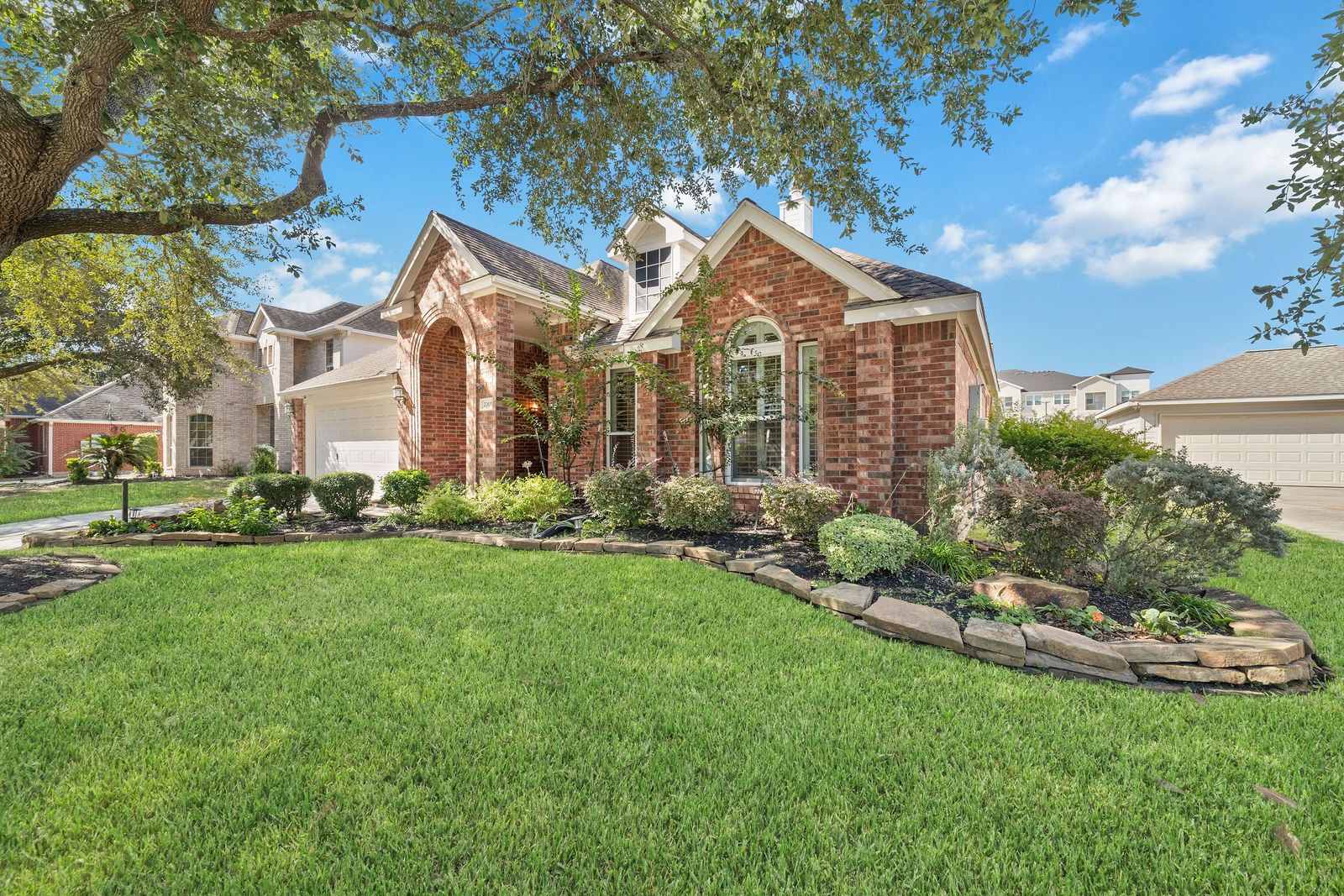 Tasteful landscaping and mature tree in the front yard